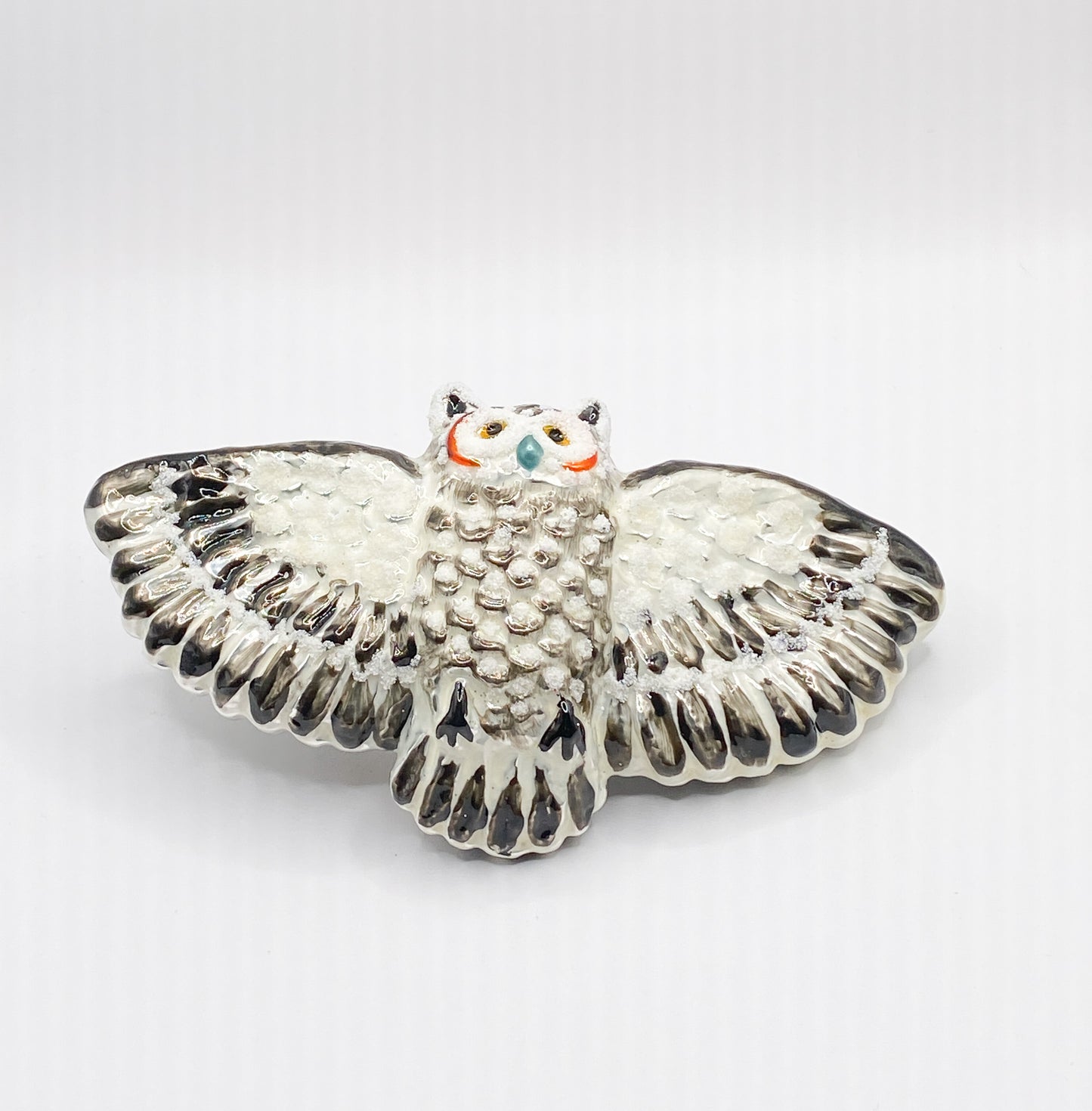 Flying white-grey owl