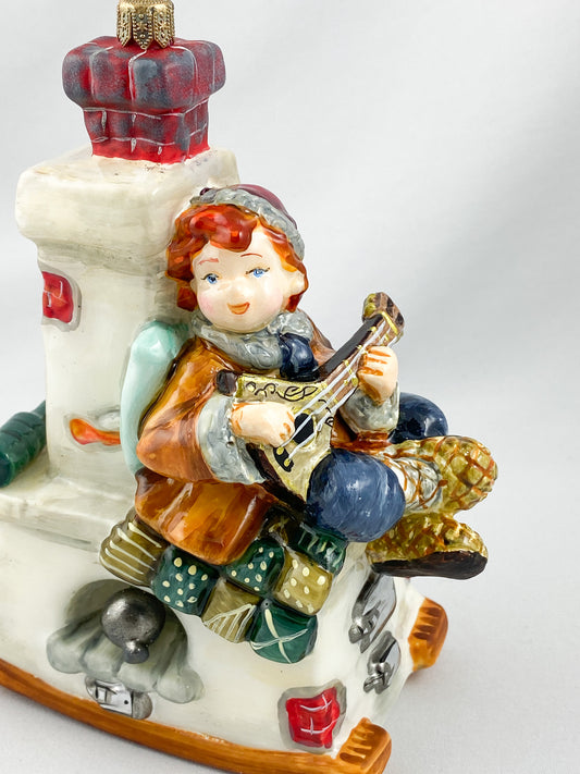 Emil sits on the stove bench and plays the balalaika, AtlasArt