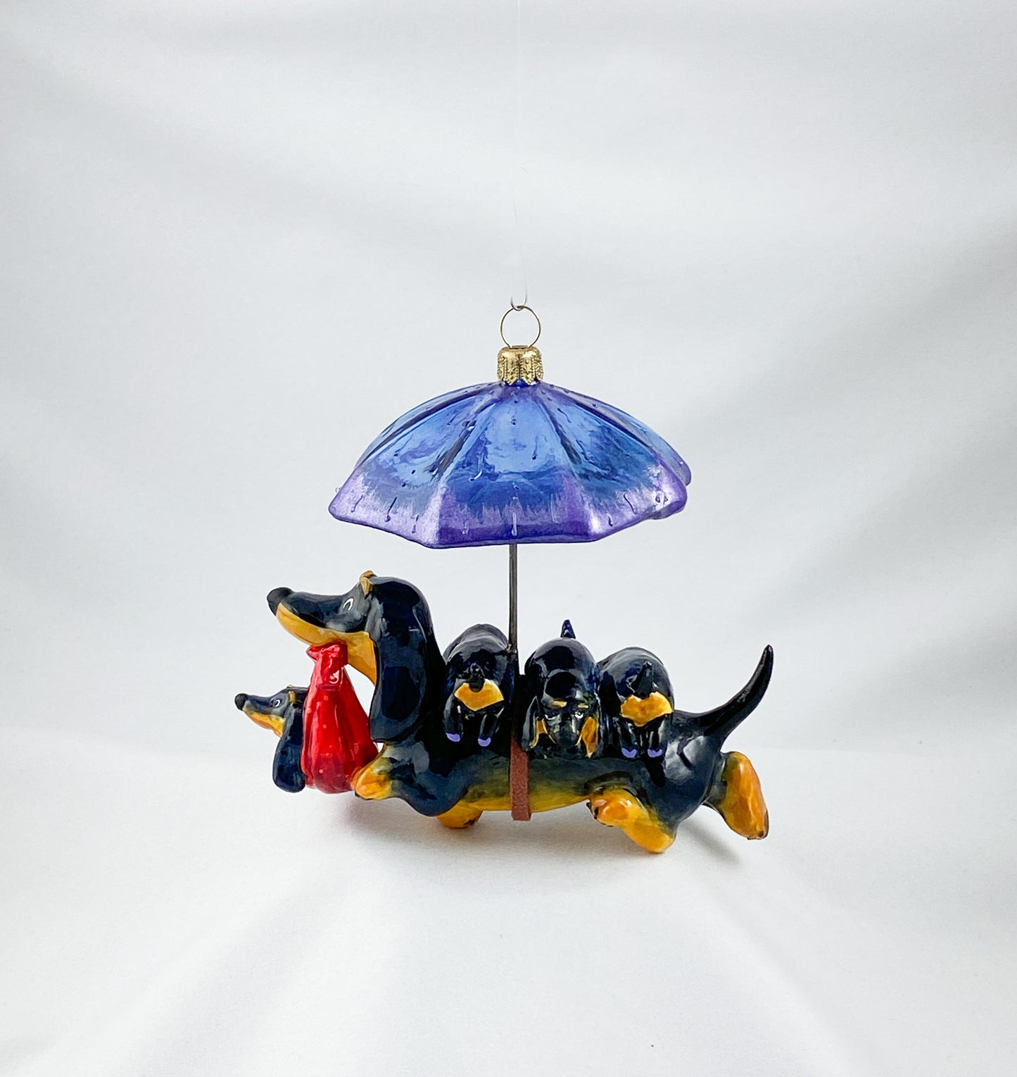 Mama dachshund walks with the baby dachshunds in the rain, AtlasArt