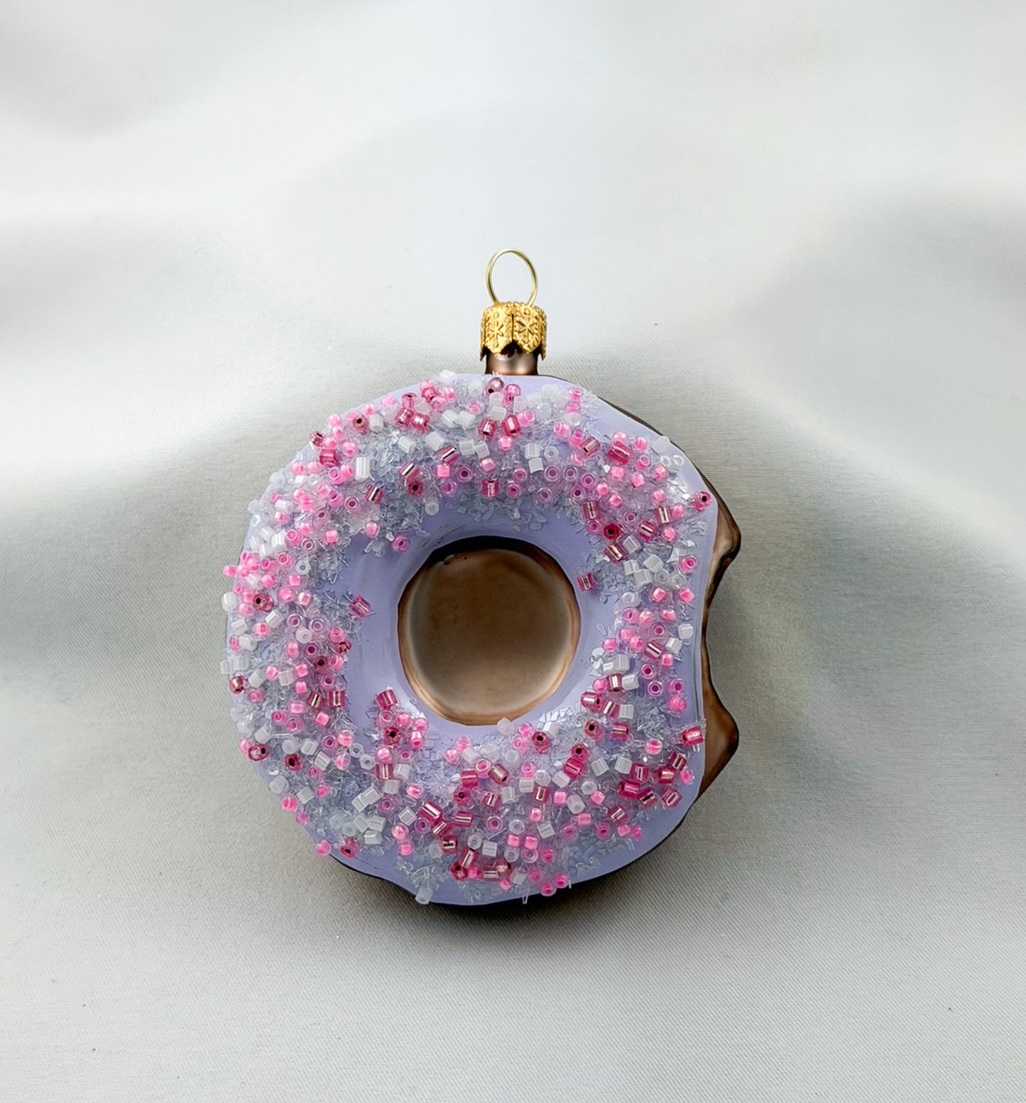 Donut with purple frosting and pink sprinkles