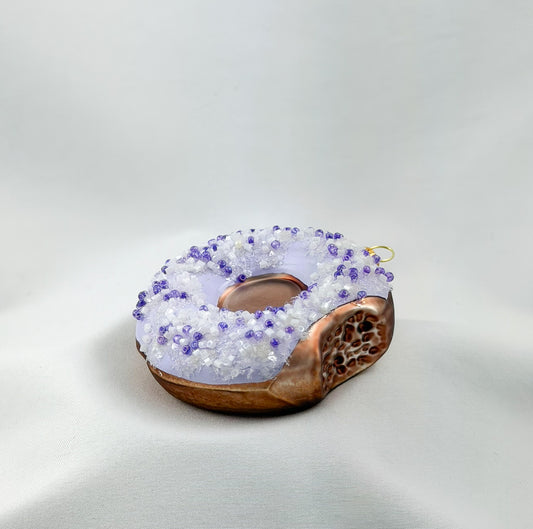 Donut with purple icing and purple sprinkles