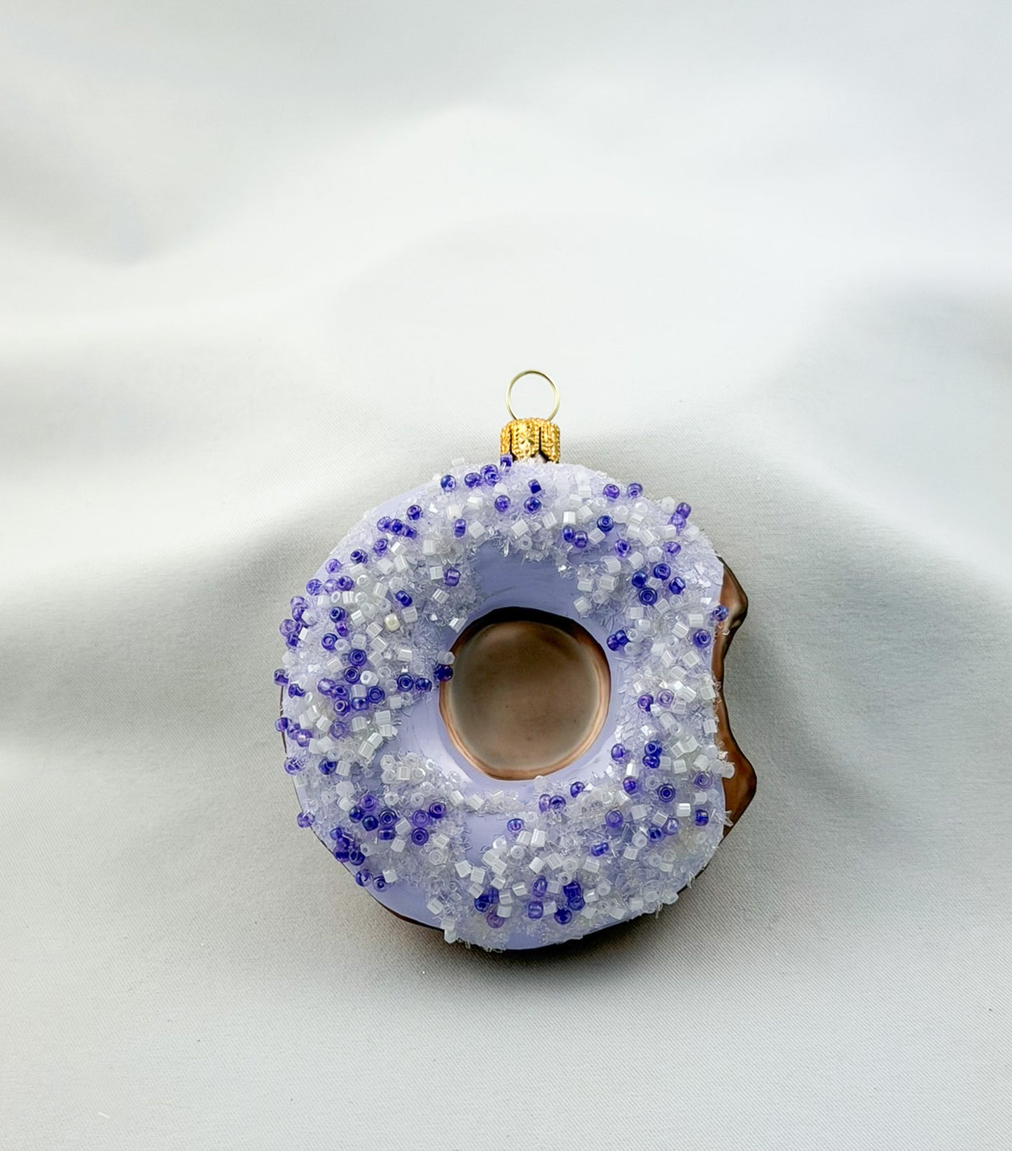 Donut with purple icing and purple sprinkles