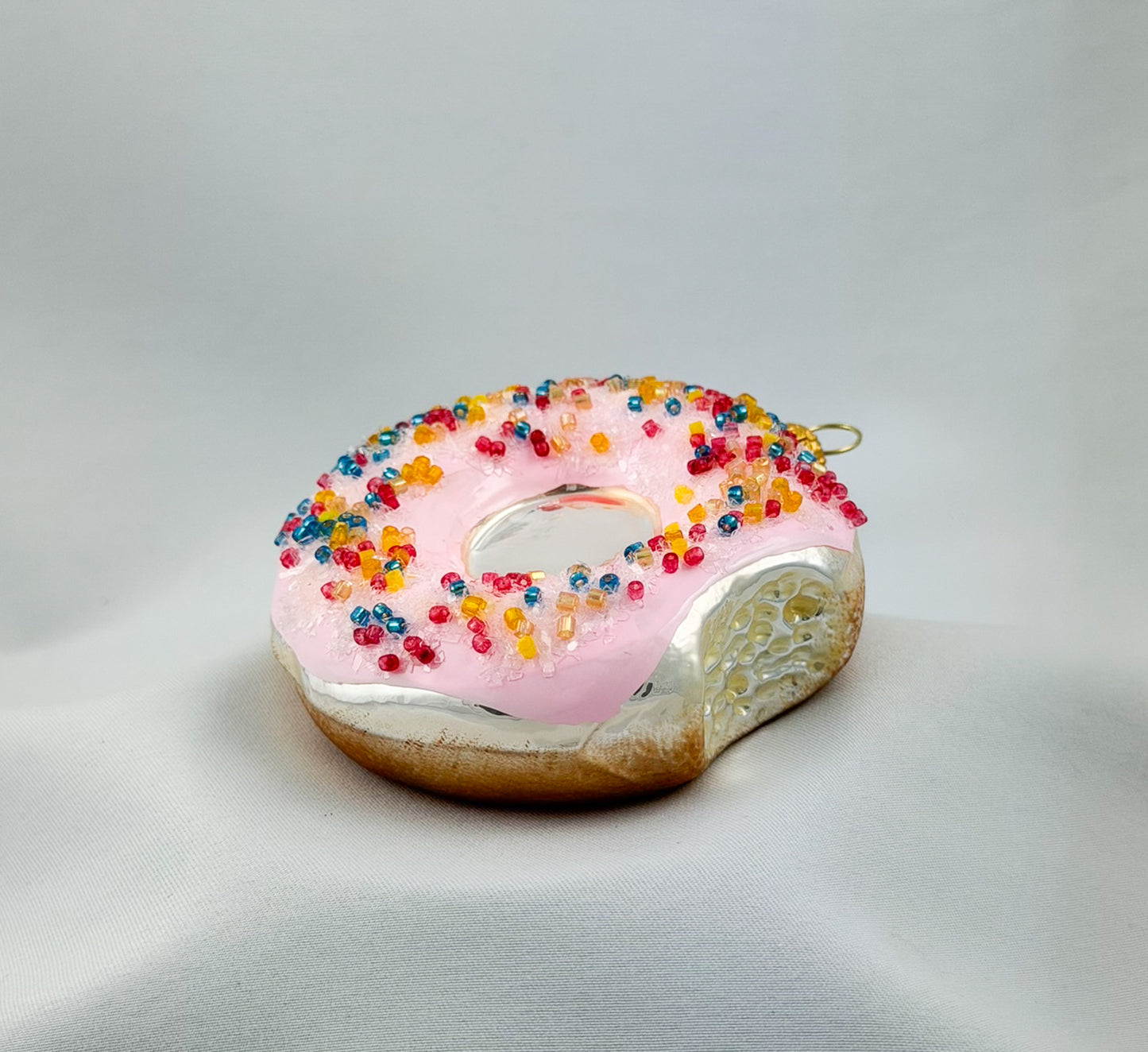 Donut with pink frosting and colorful sprinkles