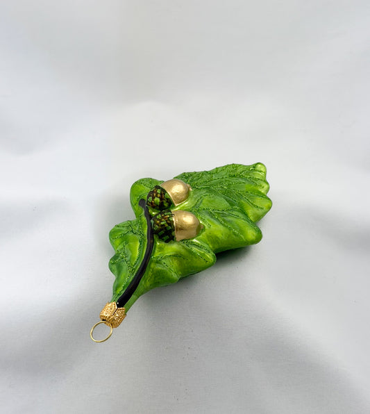 Green oak leaf with two acorns