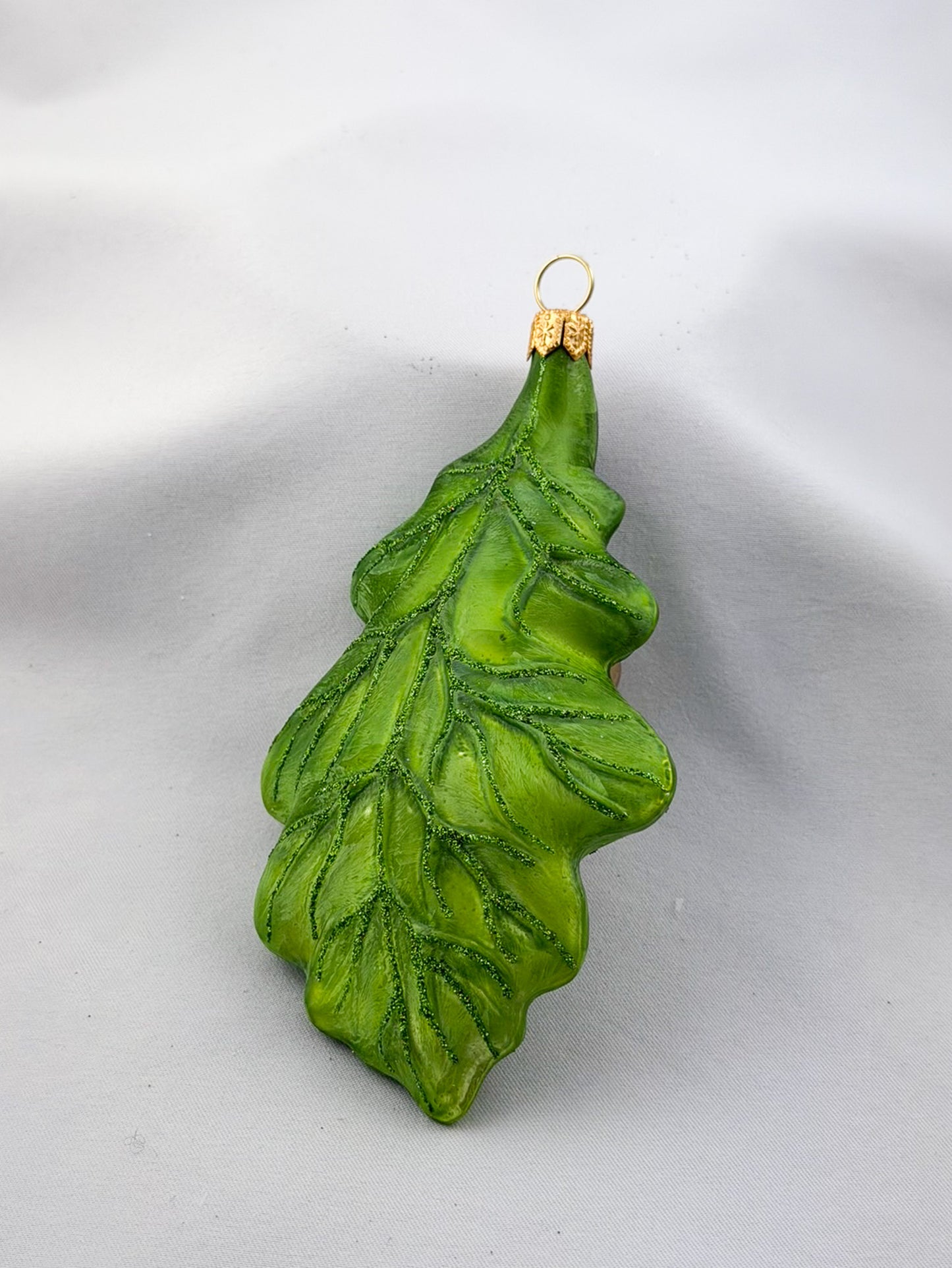 Green oak leaf with two acorns