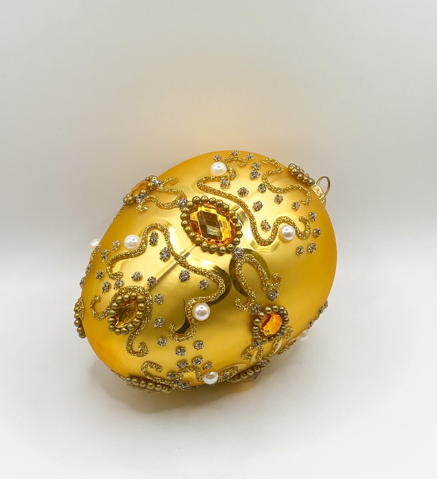 Golden Faberge egg baroque with pearls and golden gemstones