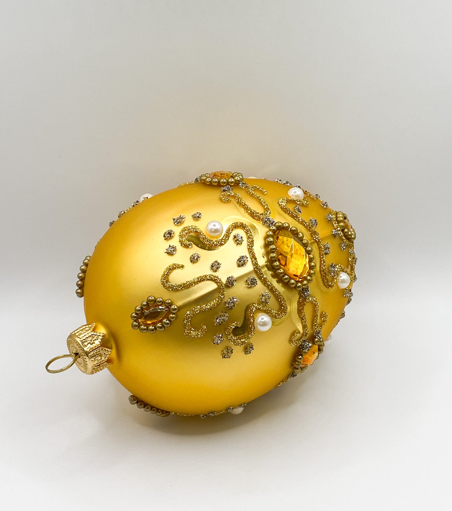 Golden Faberge egg baroque with pearls and golden gemstones