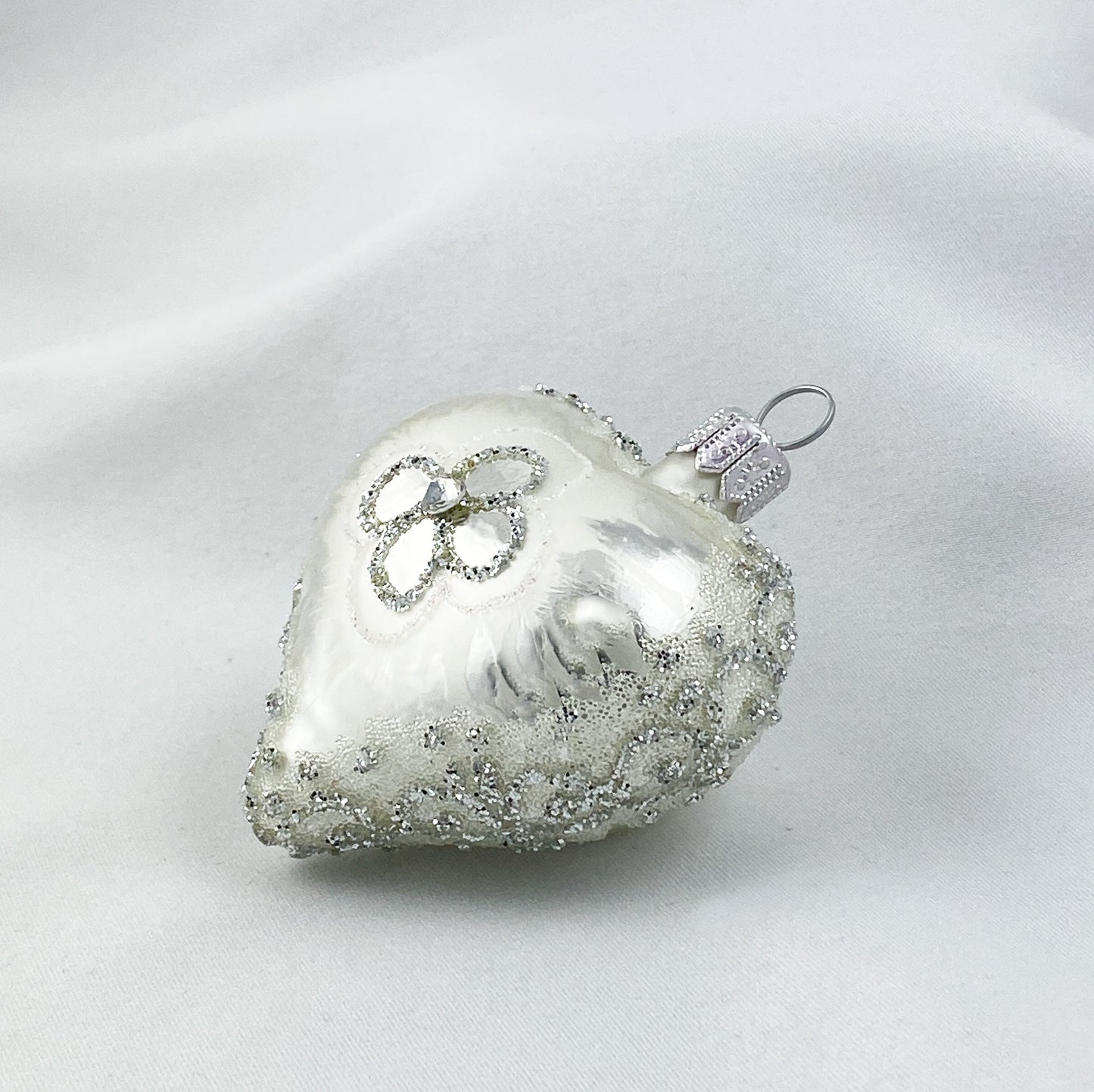 Silbernes Herz mit stilisierter Blüte