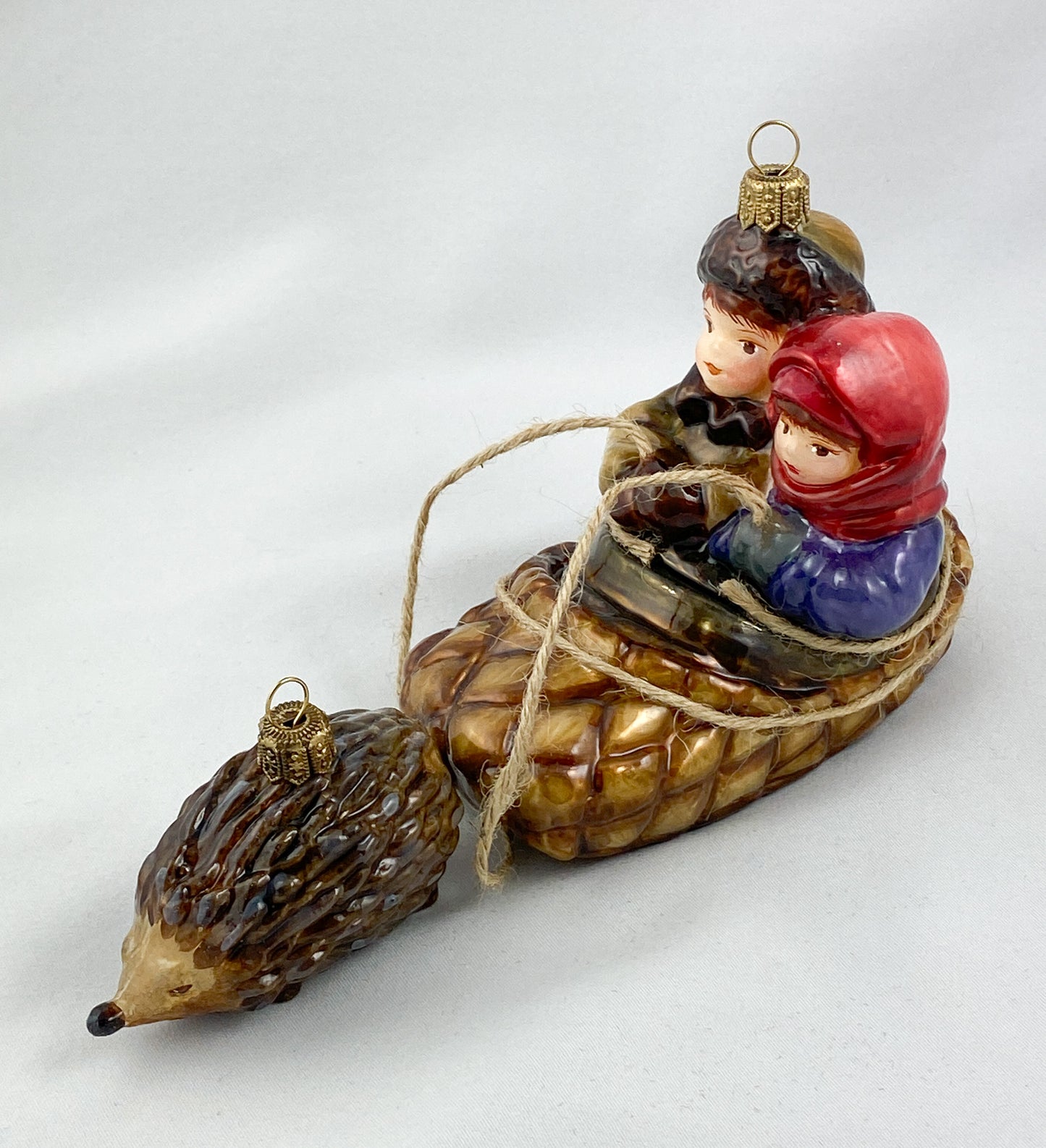 Two children in a hedgehog sleigh, set of 2, in a wooden box