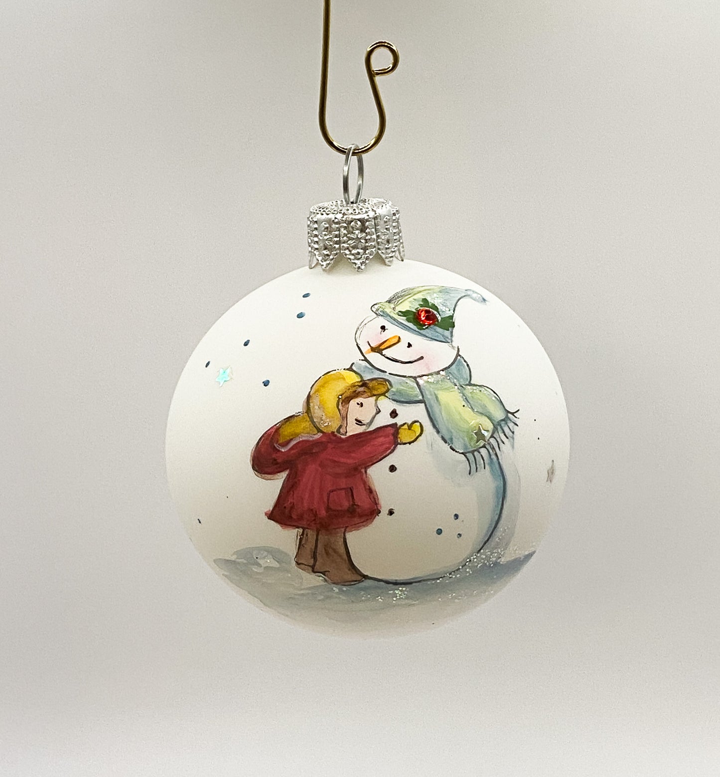 Ball snowman with child in red coat