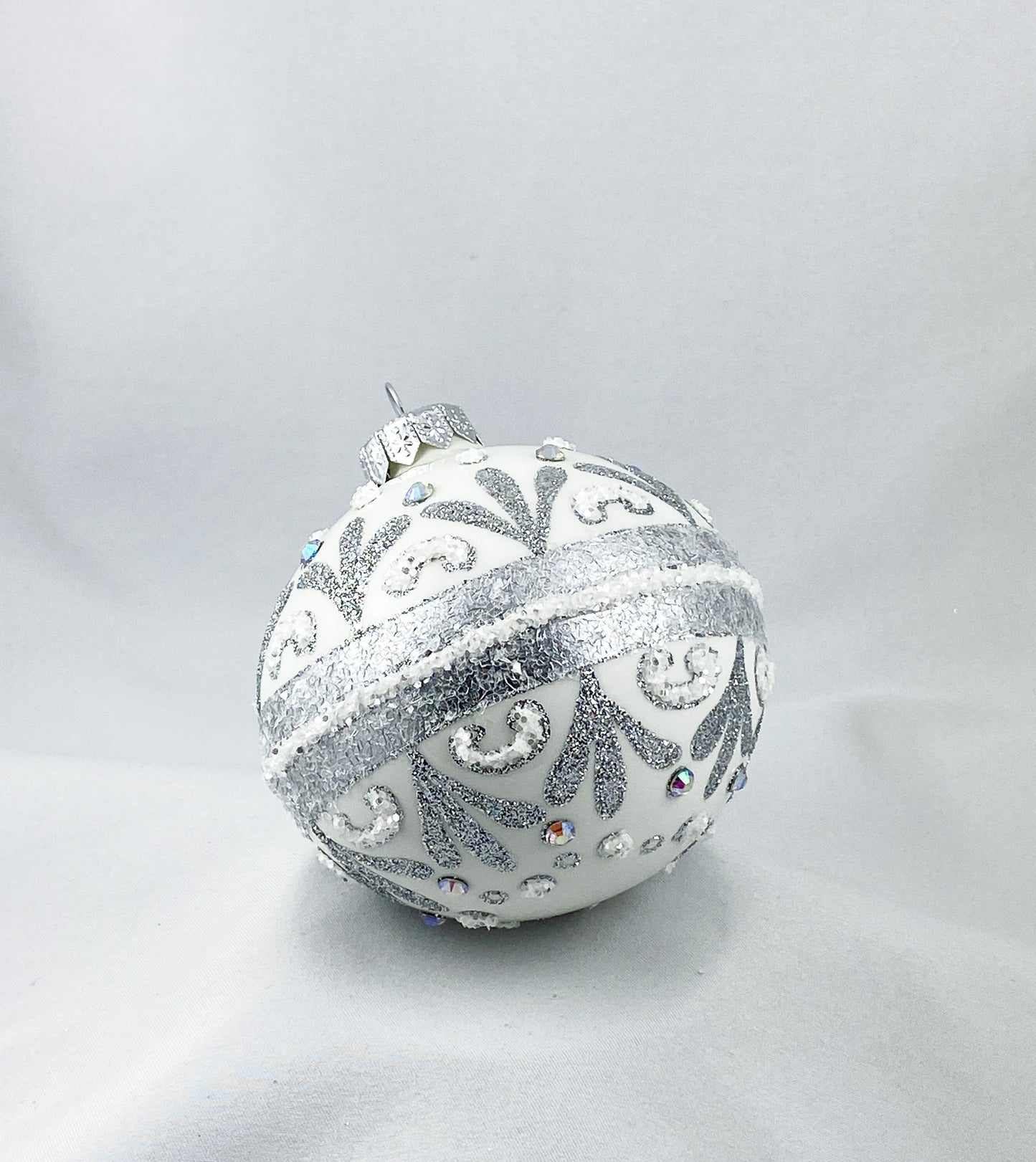 White ball with stylized leaves and rocaille motif