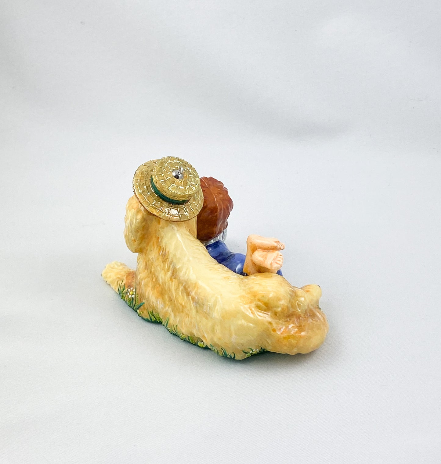 The girl is playing with the Golden Retriever in the summer meadow. AtlasArt