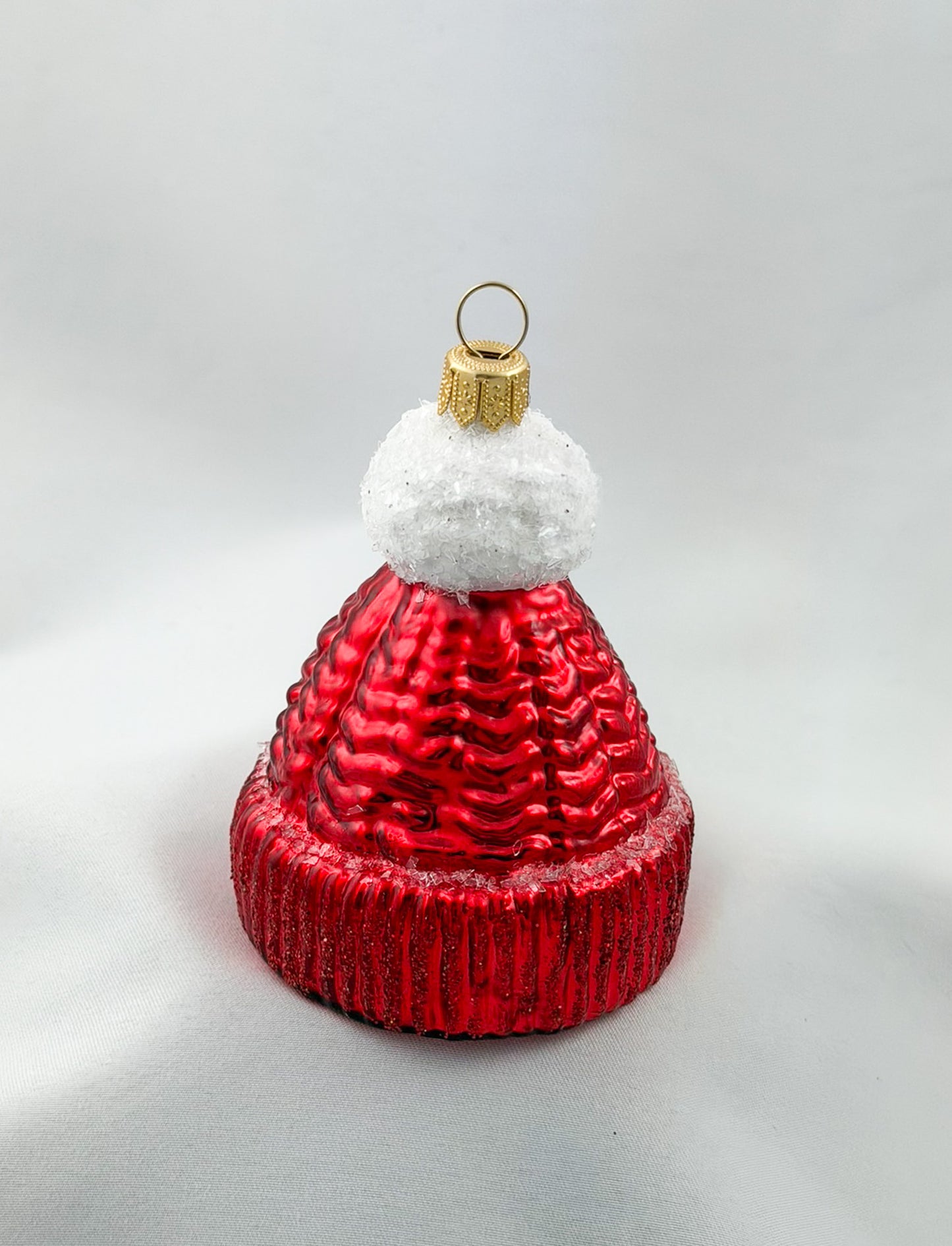 Red knitted hat with white pompom