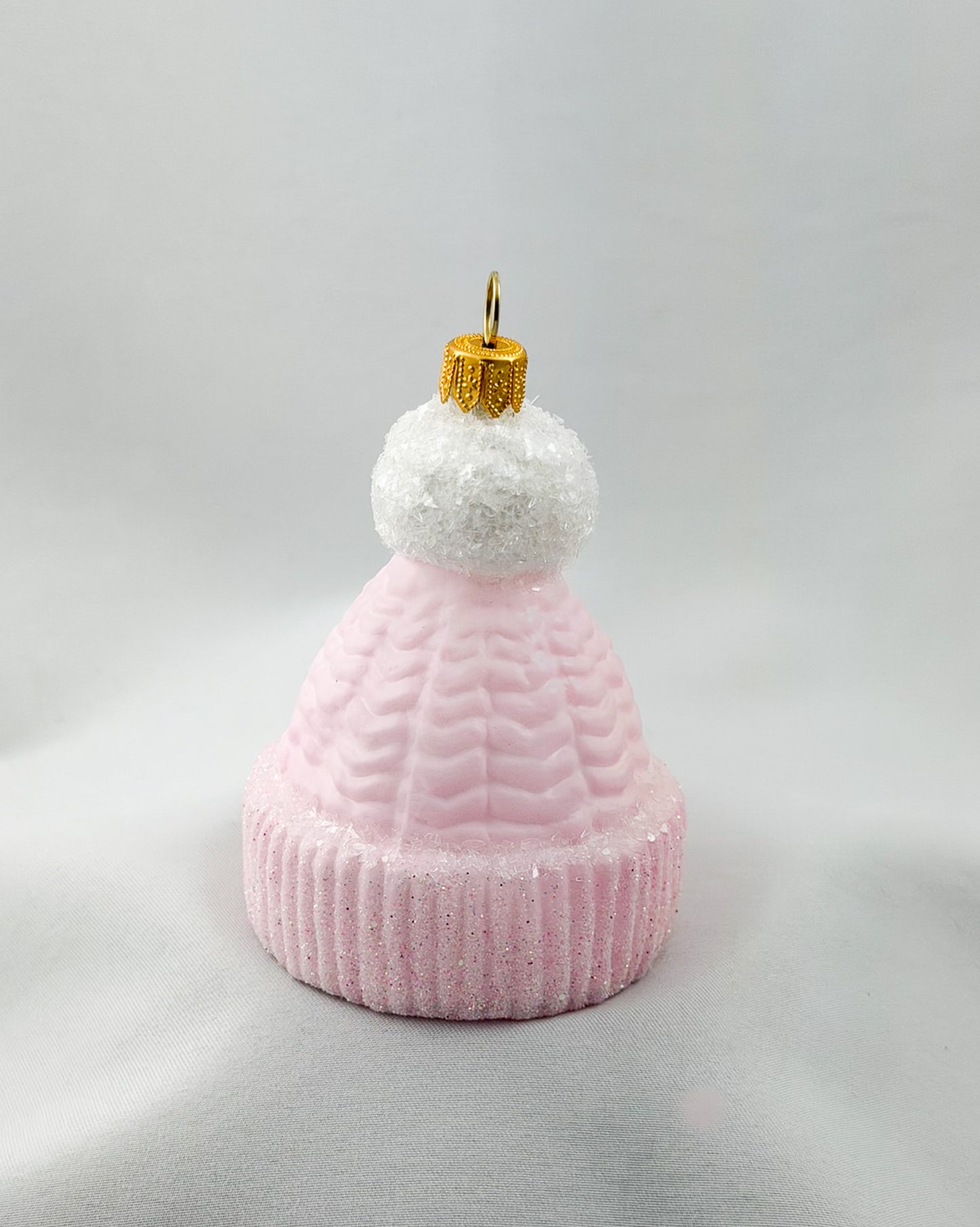 Pink knit beanie with white pompom