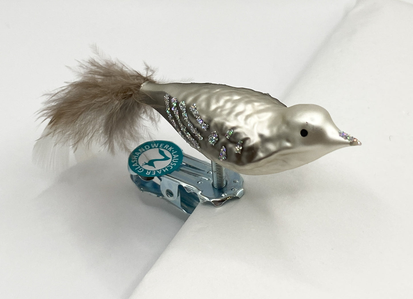 Small bird in warm grey with glitter