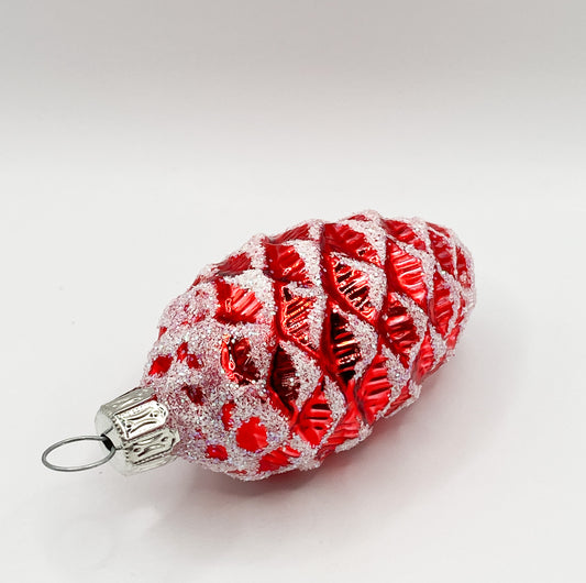Small red shiny fir cone with white glitter