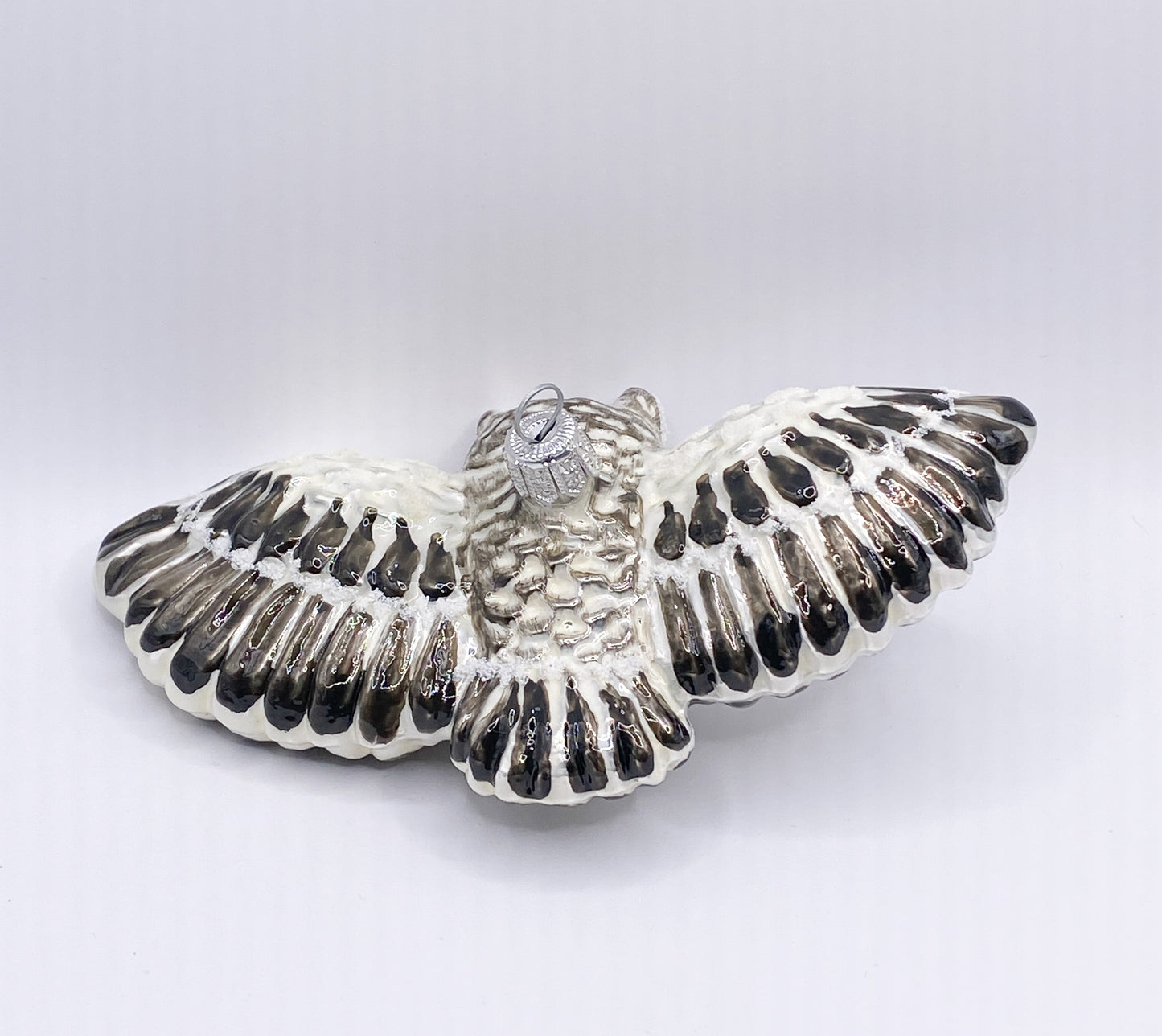 Flying white-grey owl