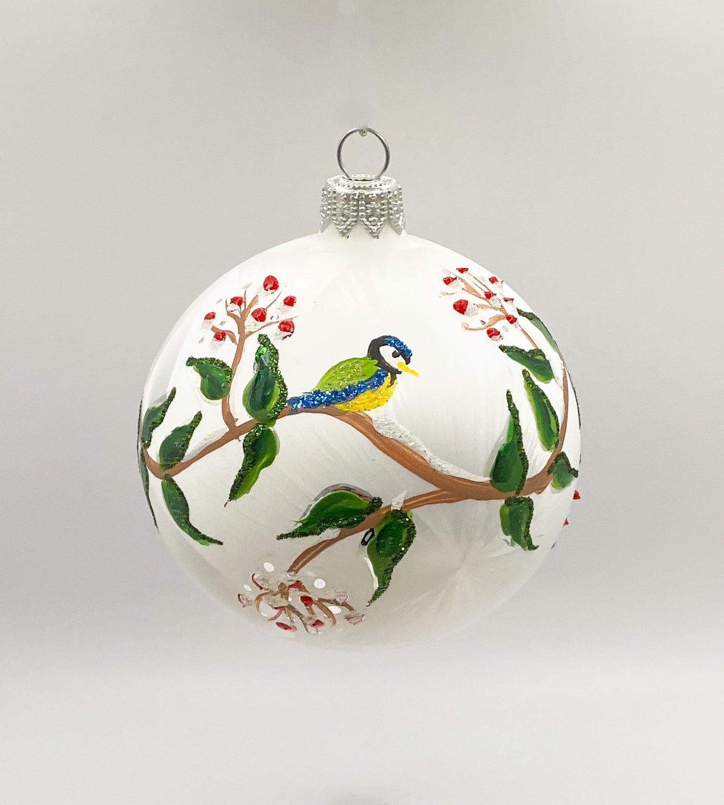 White ball with blue tits on leaf tendrils