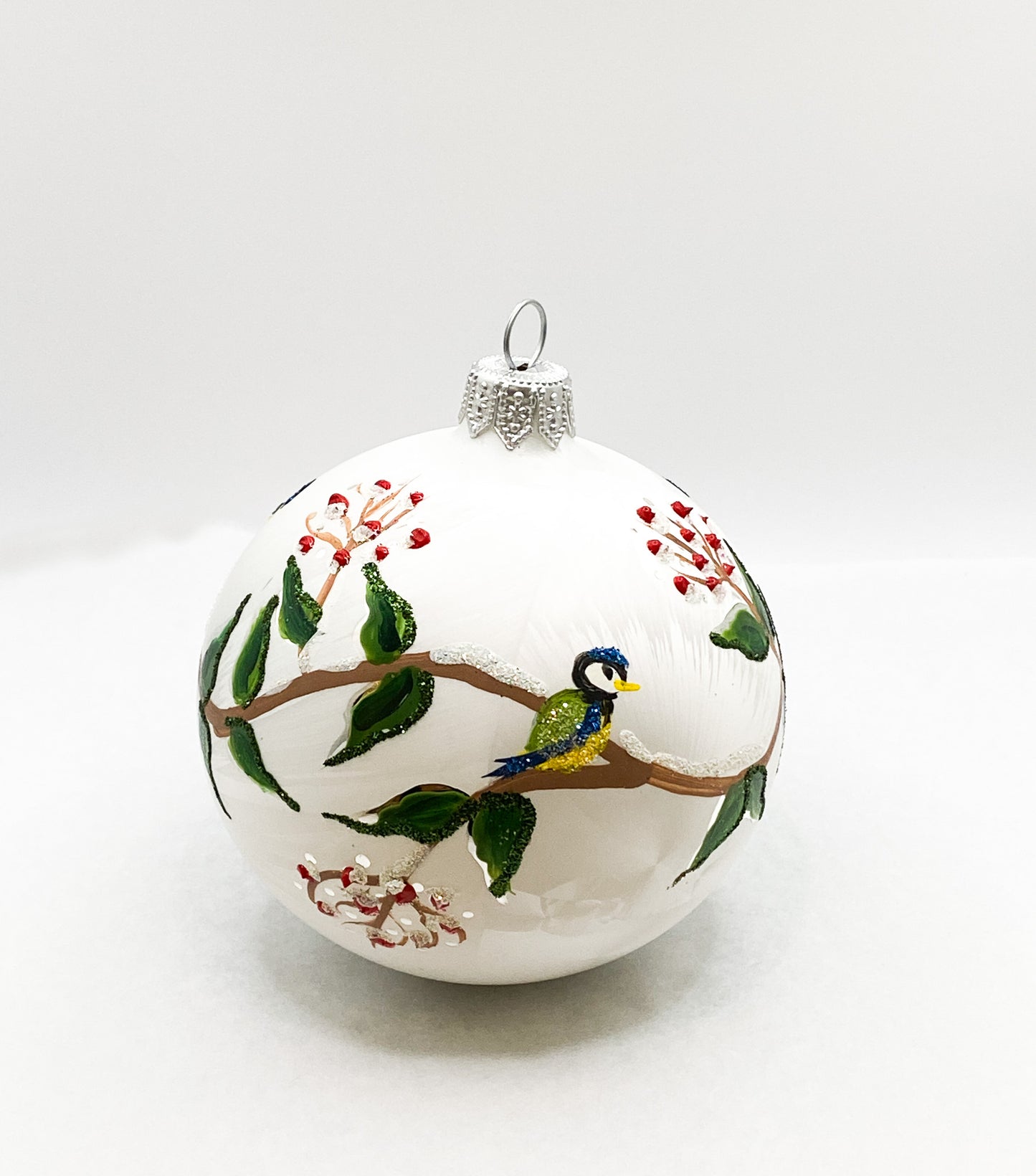 White ball with blue tits on leaf tendrils