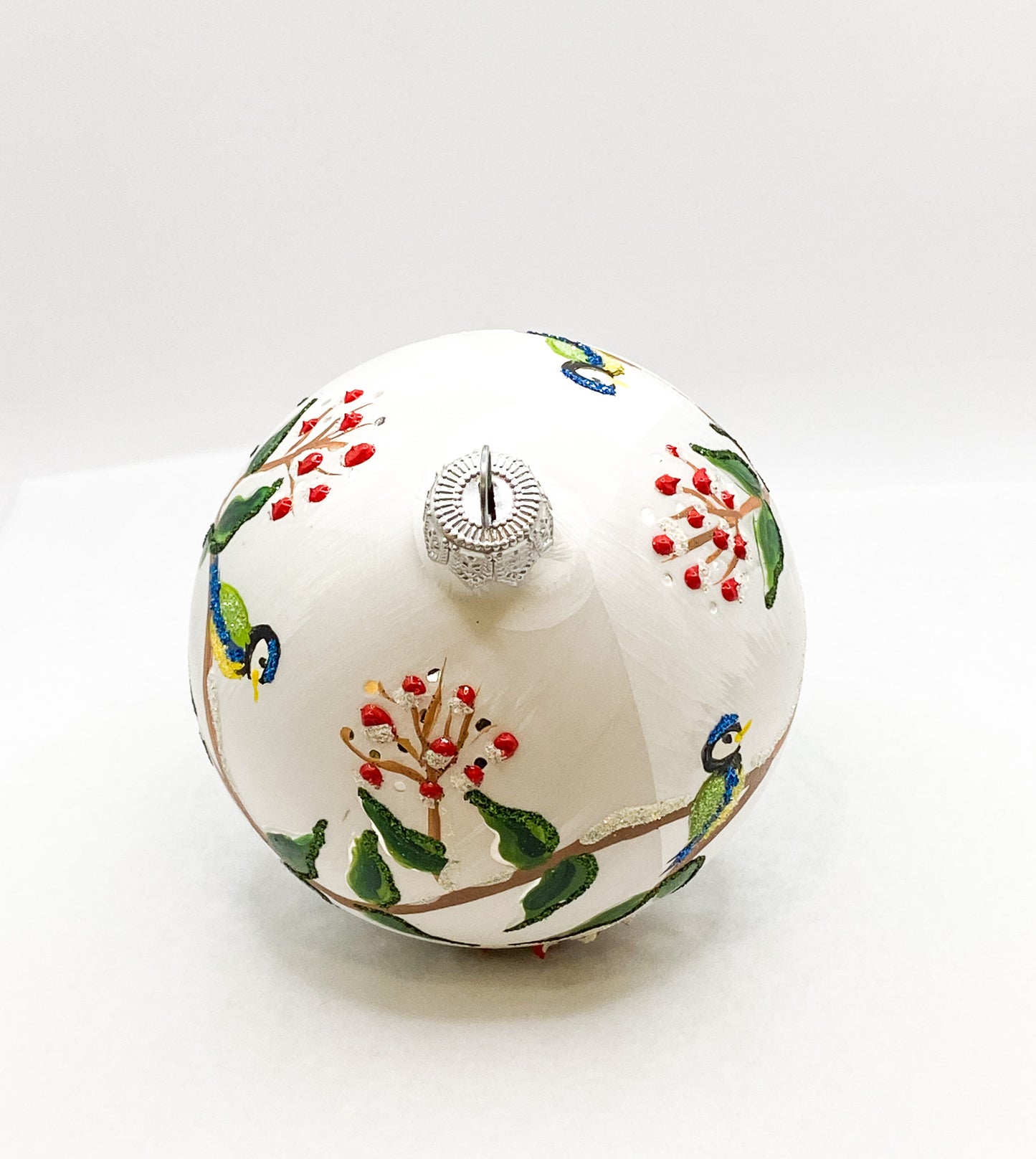 White ball with blue tits on leaf tendrils