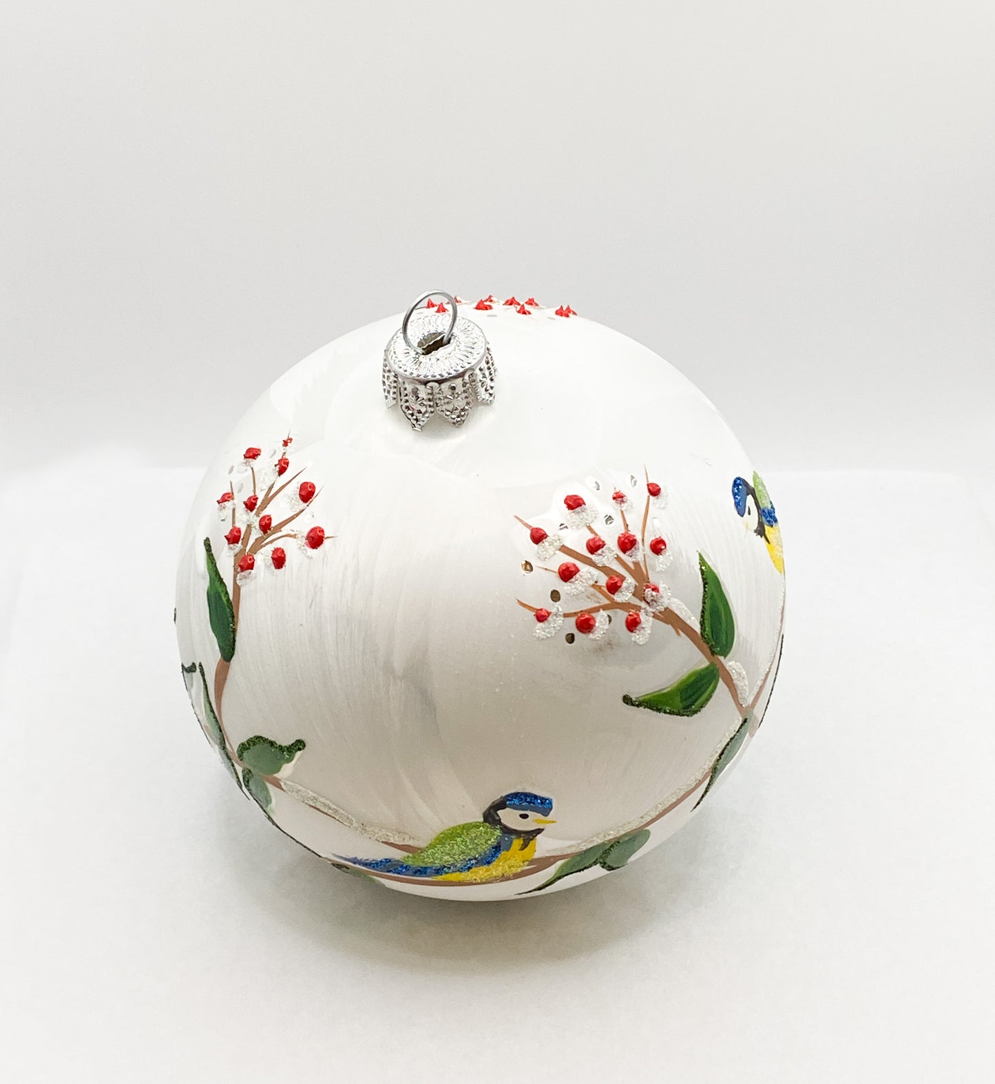 White ball with blue tits on leaf tendrils