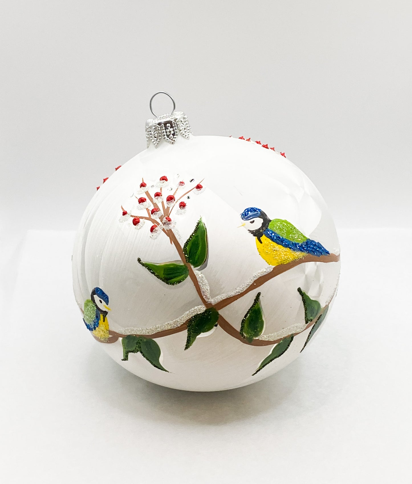 White ball with blue tits on leaf tendrils