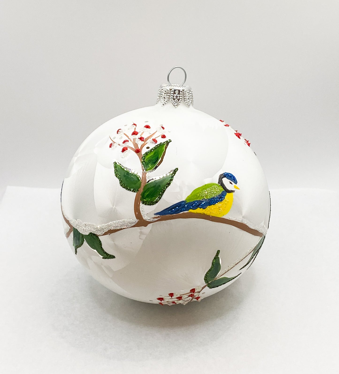 White ball with blue tits on leaf tendrils