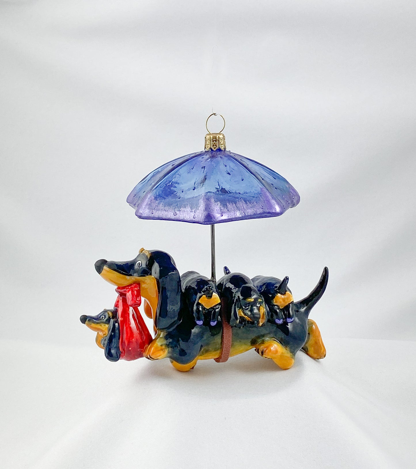 Mama dachshund walks with the baby dachshunds in the rain, AtlasArt