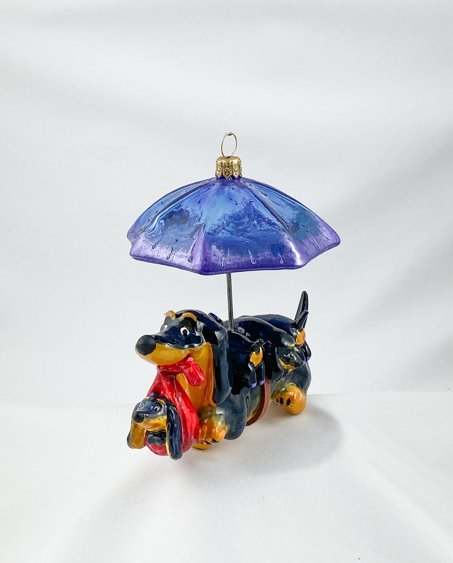 Mama dachshund walks with the baby dachshunds in the rain, AtlasArt