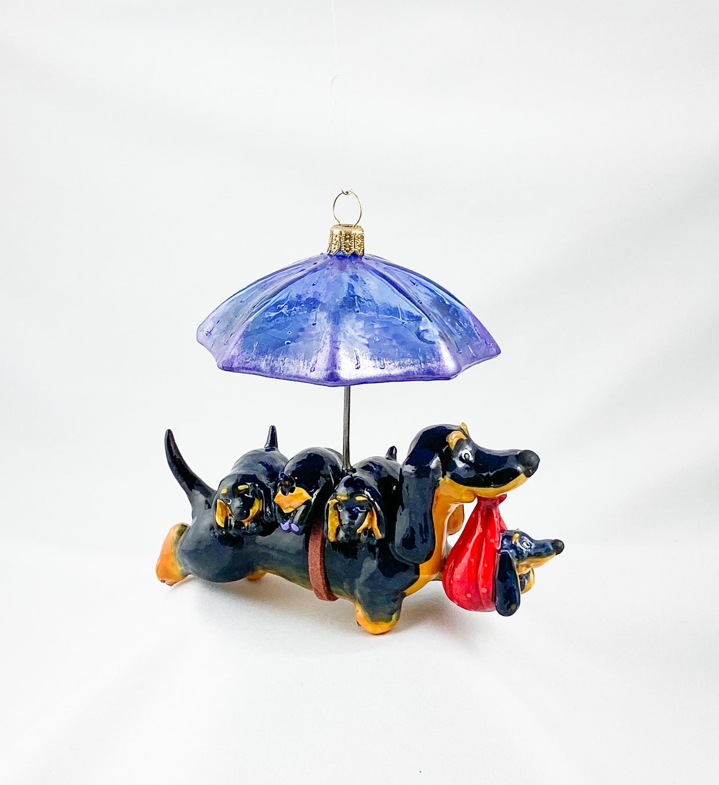 Mama dachshund walks with the baby dachshunds in the rain, AtlasArt