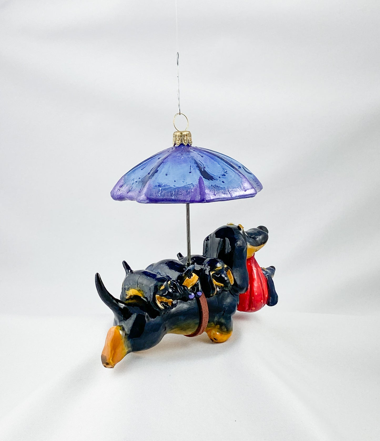 Mama dachshund walks with the baby dachshunds in the rain, AtlasArt