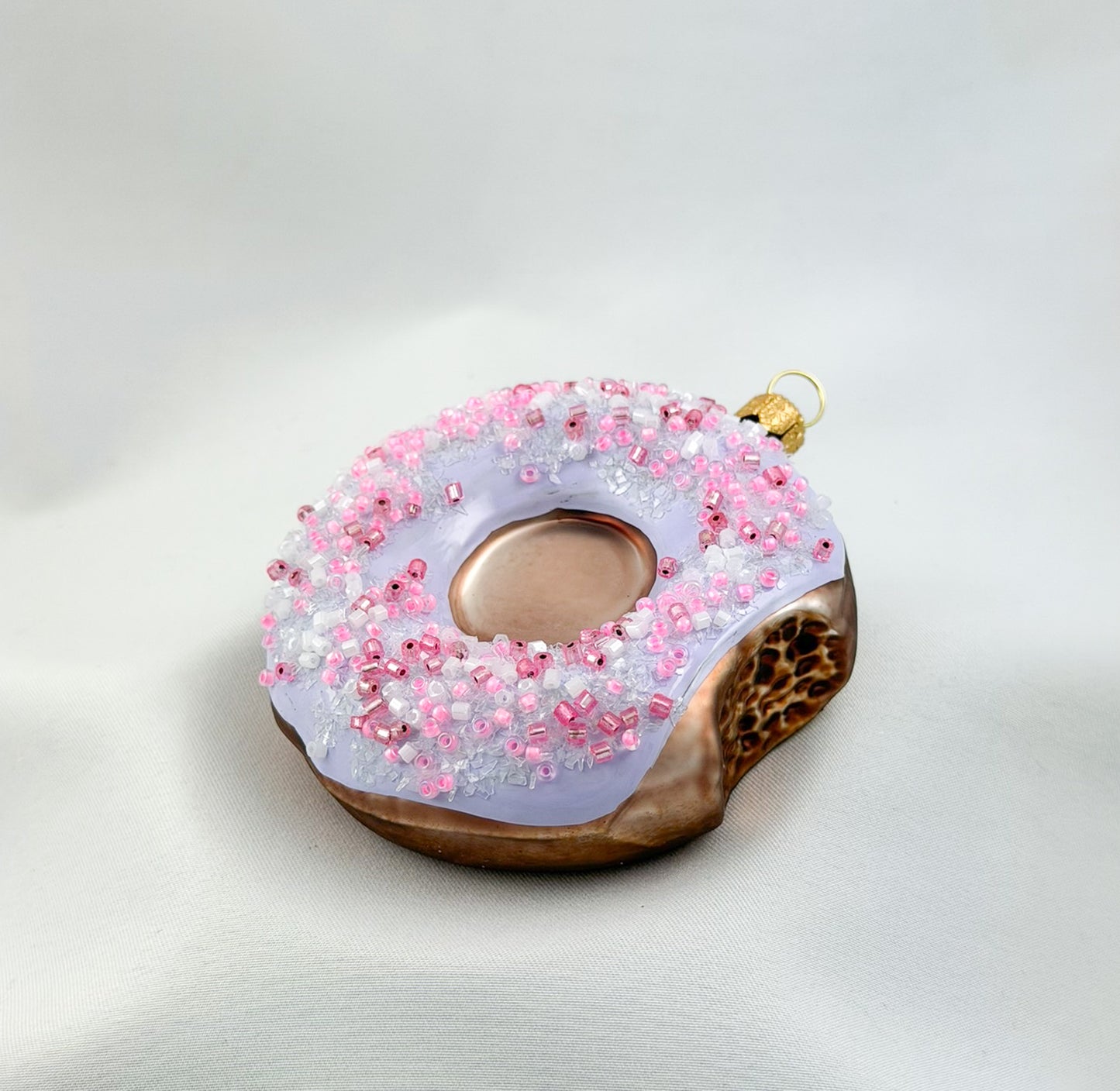 Donut with purple frosting and pink sprinkles