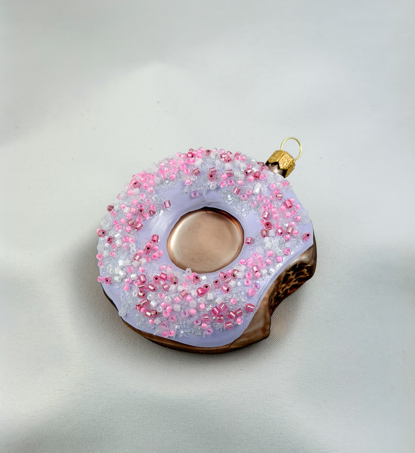 Donut with purple frosting and pink sprinkles
