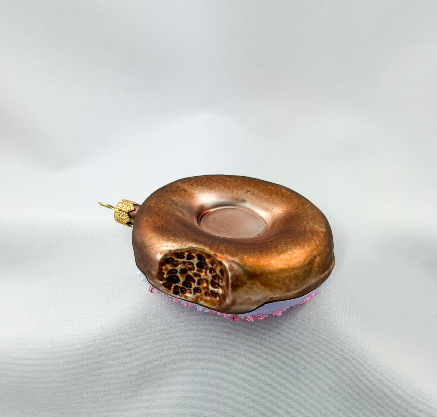 Donut with purple frosting and pink sprinkles
