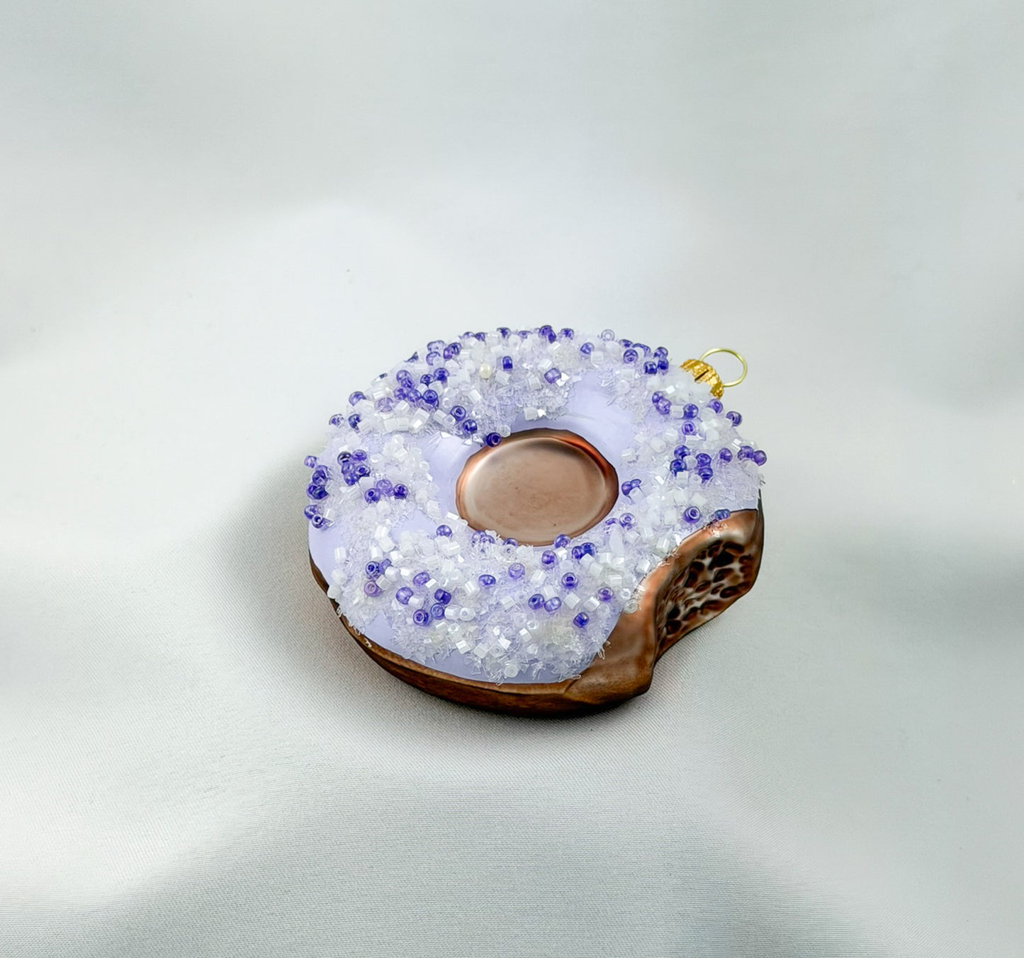 Donut with purple icing and purple sprinkles