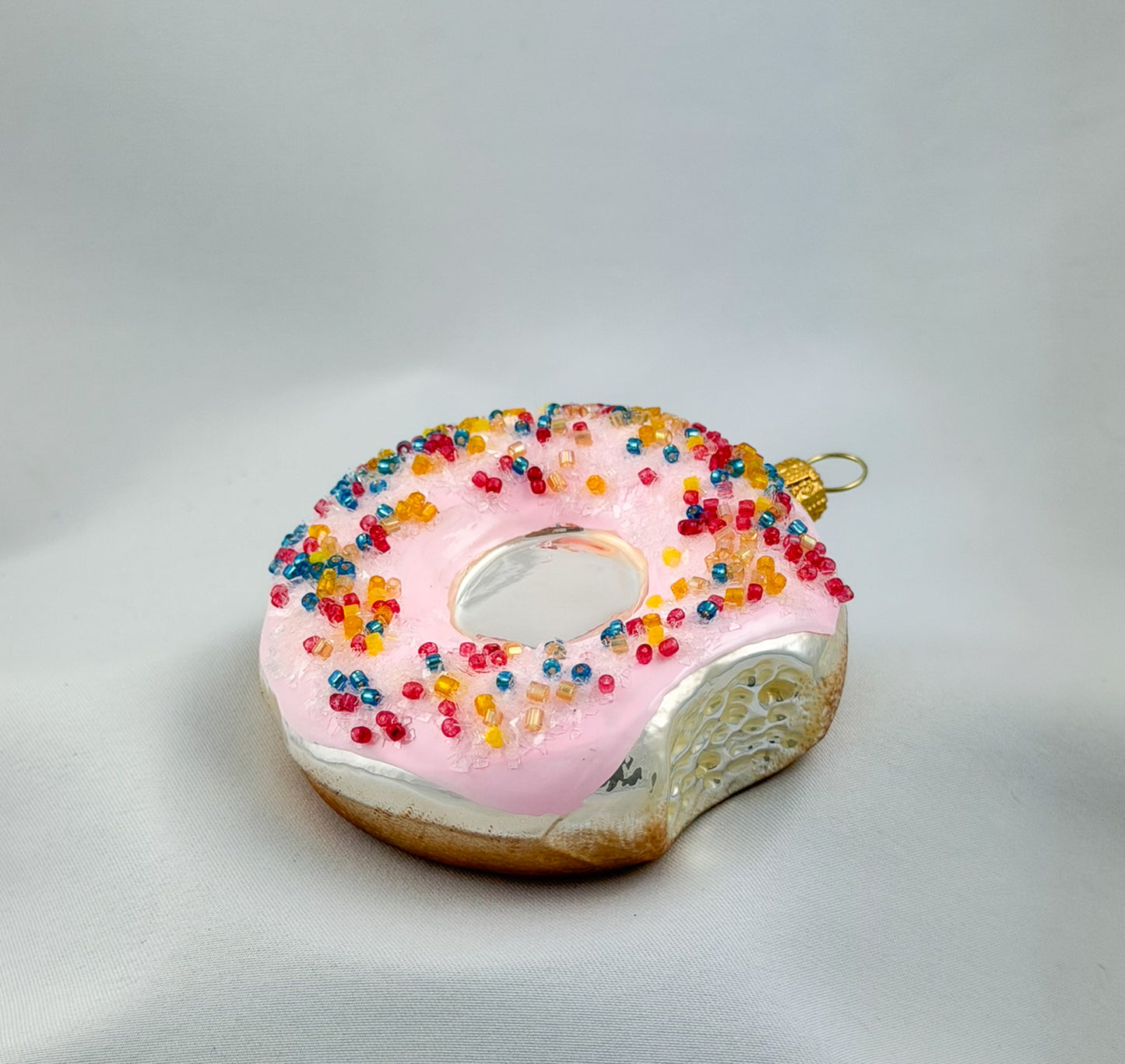 Donut with pink frosting and colorful sprinkles