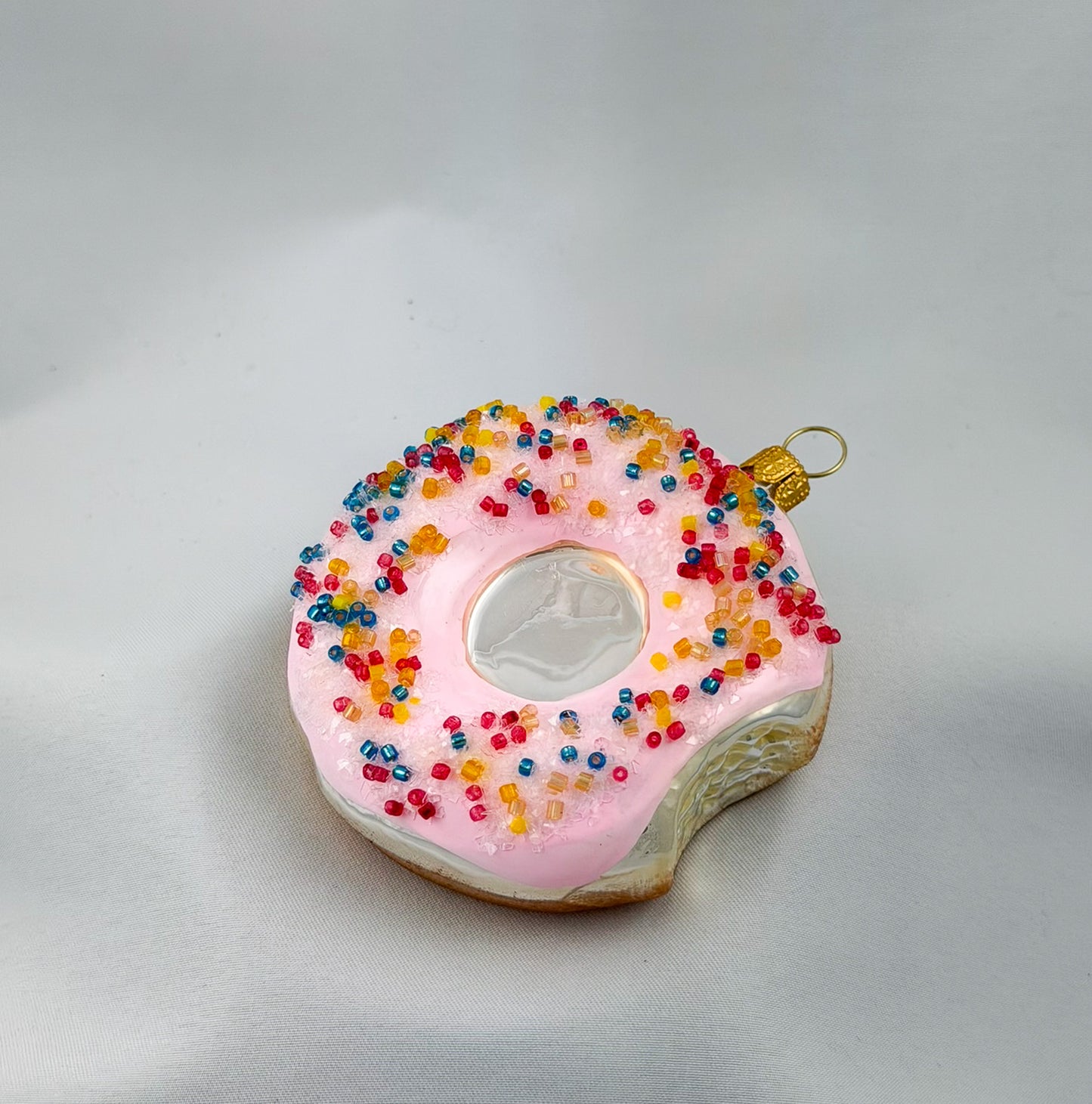Donut with pink frosting and colorful sprinkles