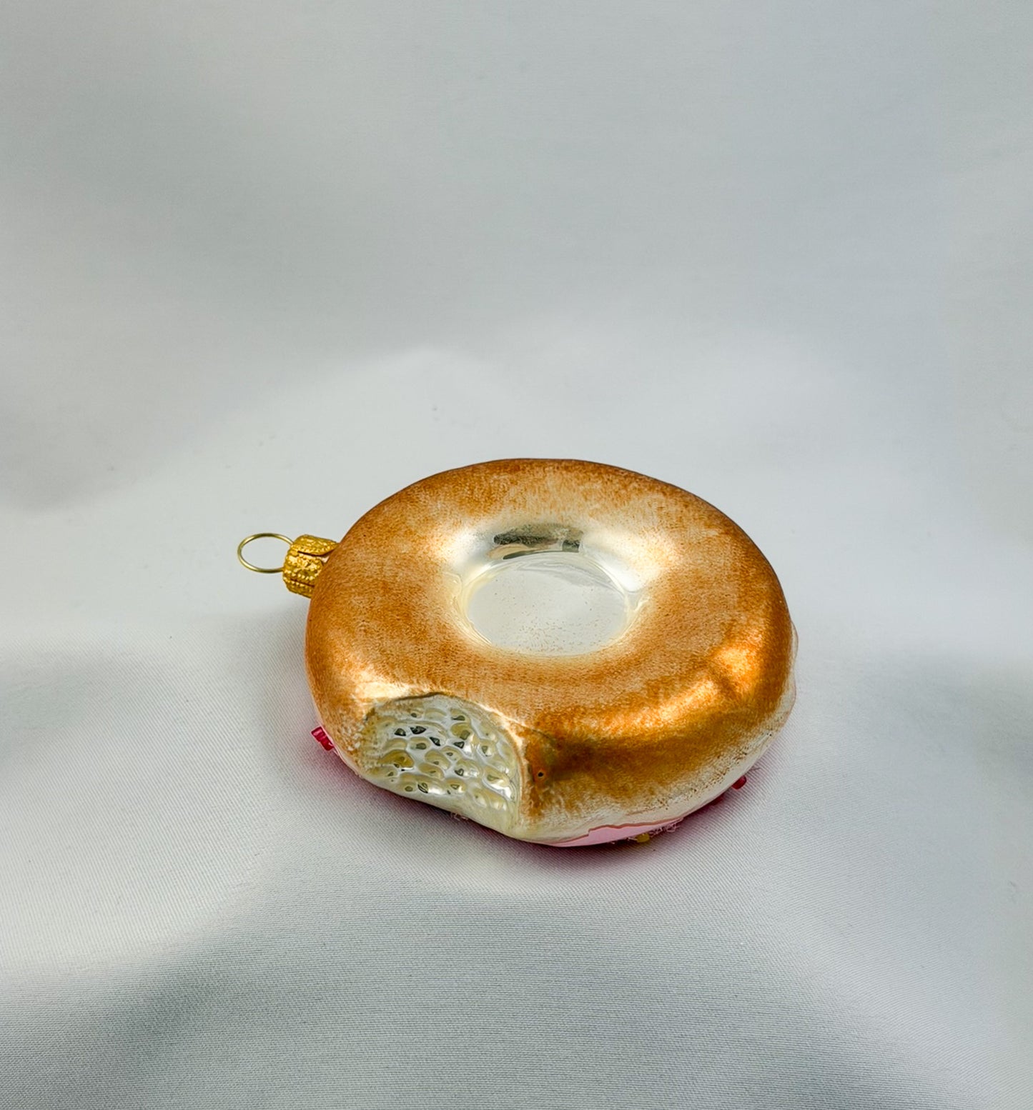 Donut with pink frosting and colorful sprinkles