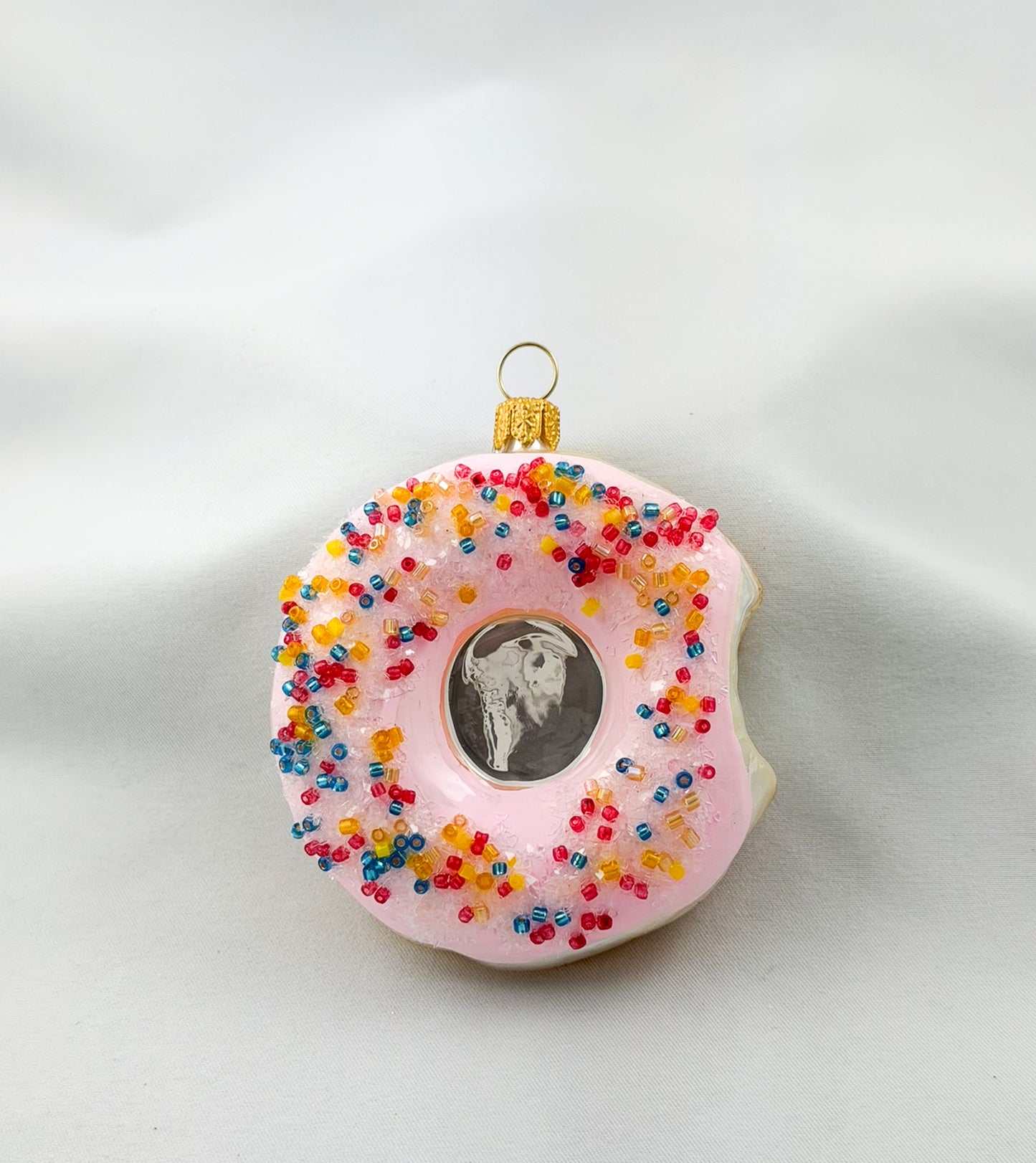 Donut with pink frosting and colorful sprinkles
