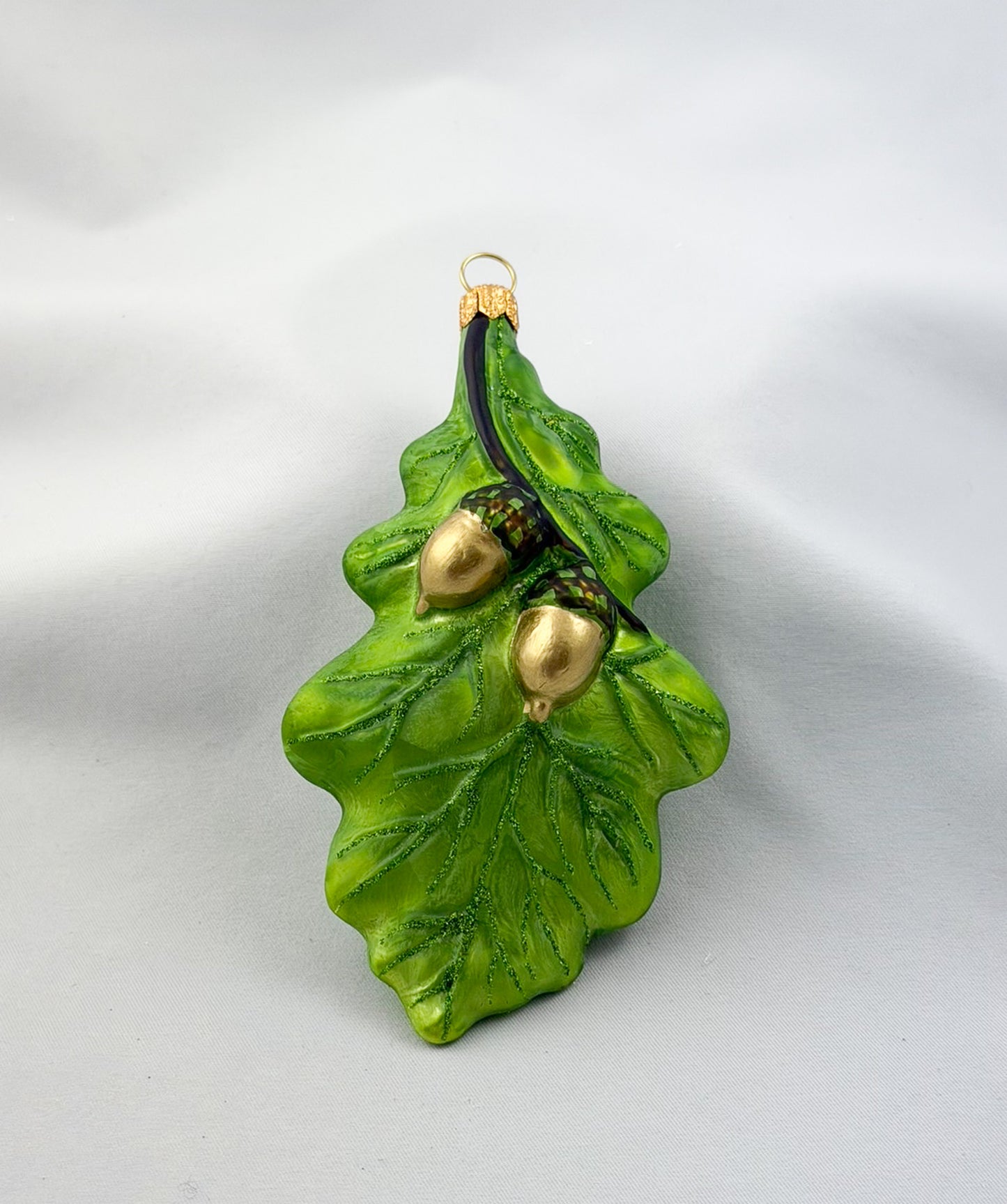 Green oak leaf with two acorns