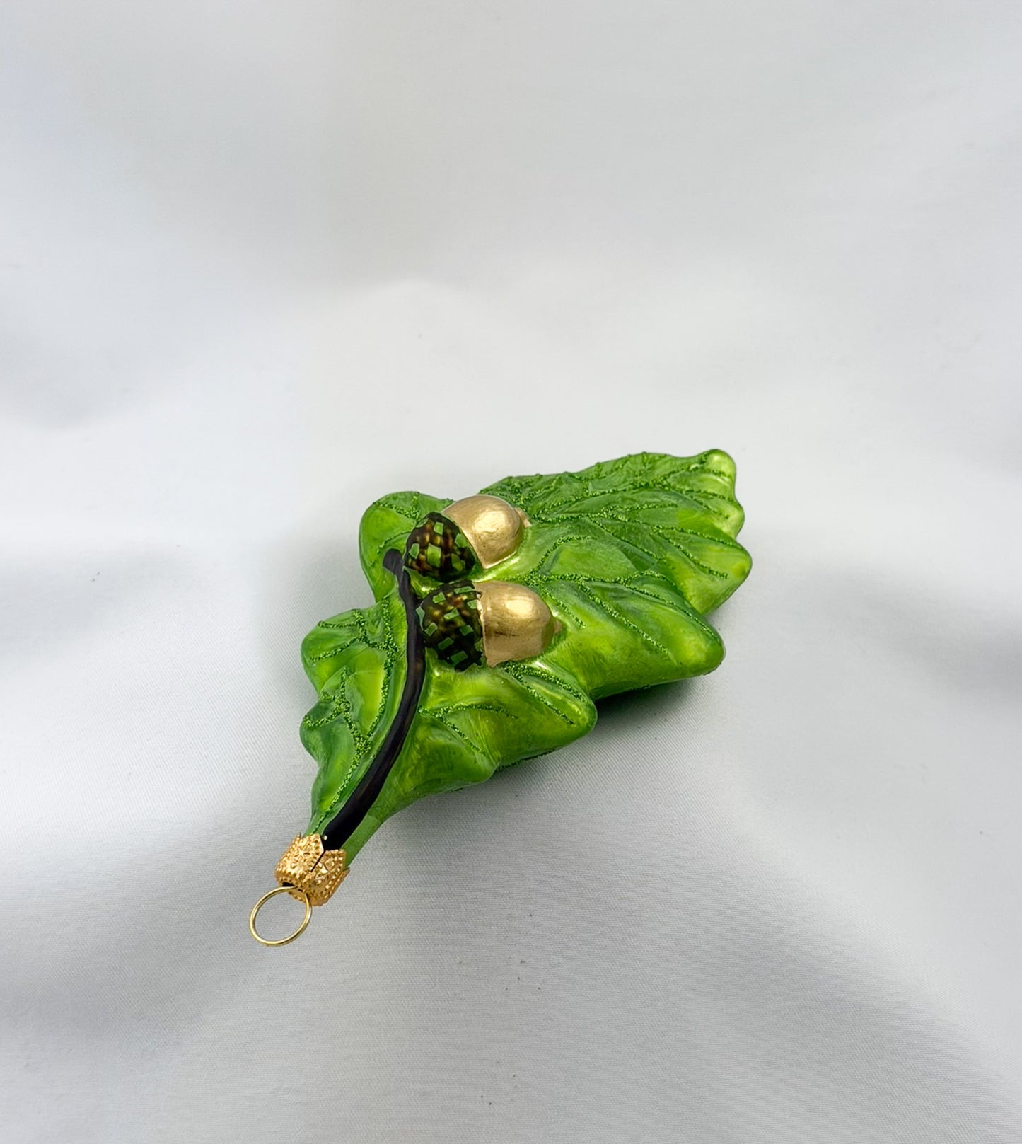 Green oak leaf with two acorns