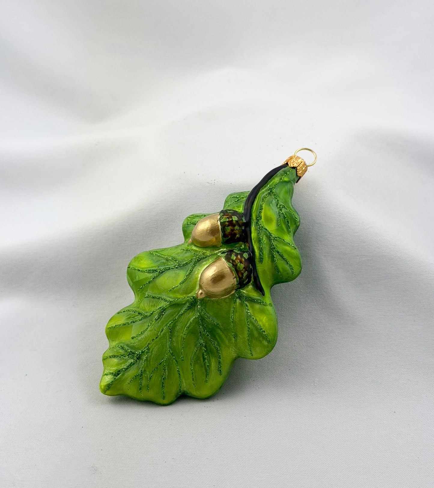 Green oak leaf with two acorns