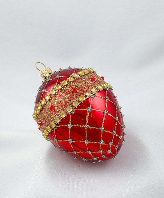 Egg-shaped shiny red with gold brocade decoration