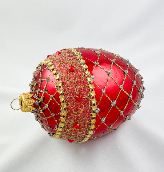 Egg-shaped shiny red with gold brocade decoration