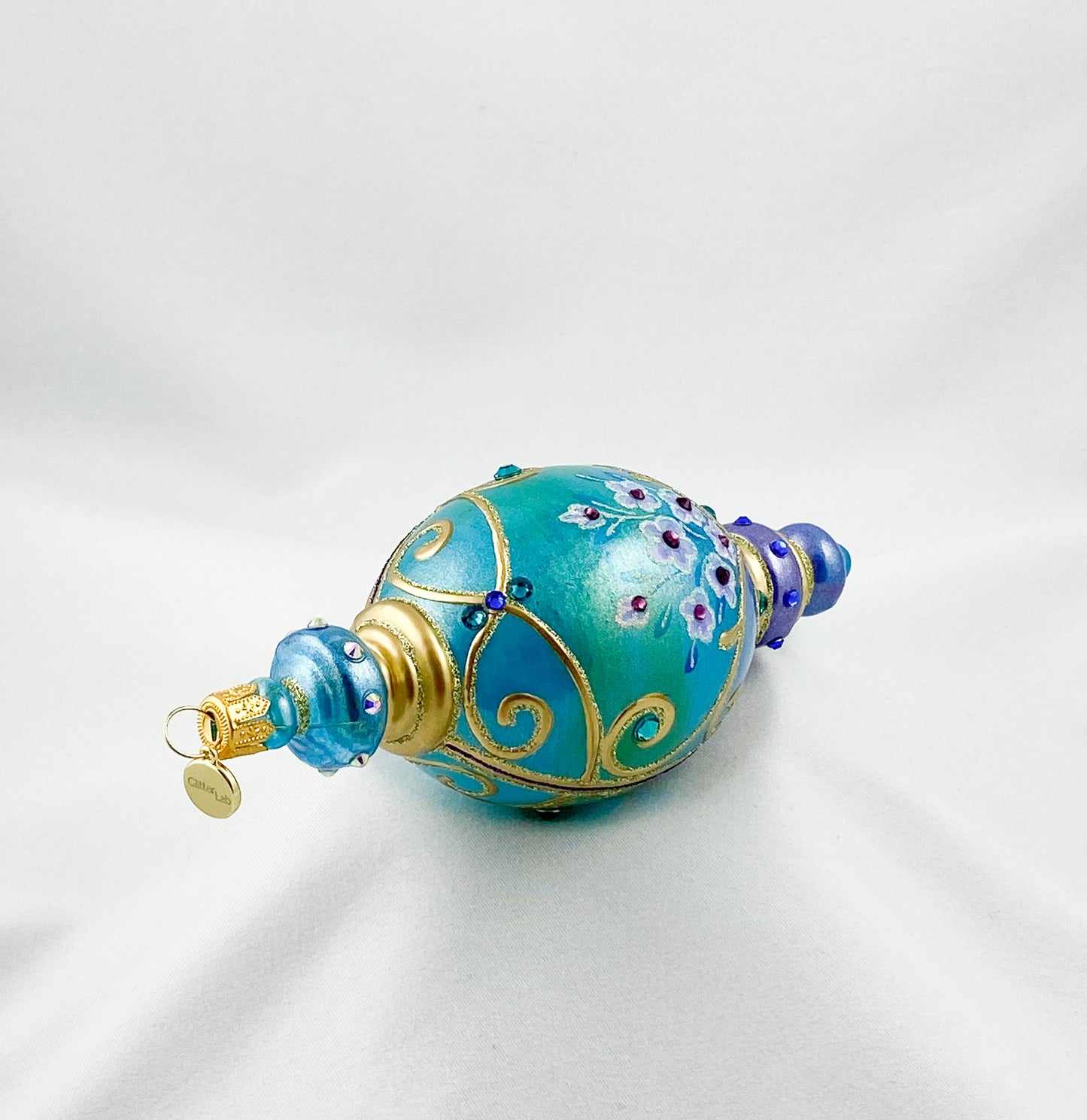 Oval drop shape in turquoise with pink flowers and glitter stones, GlitterLab