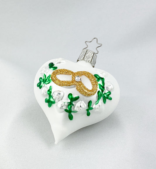 Herz mit zwei goldenen Eheringen und Blumenranken