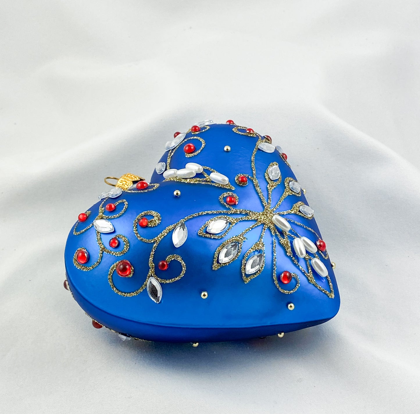 Blue heart with pearls and red gemstones