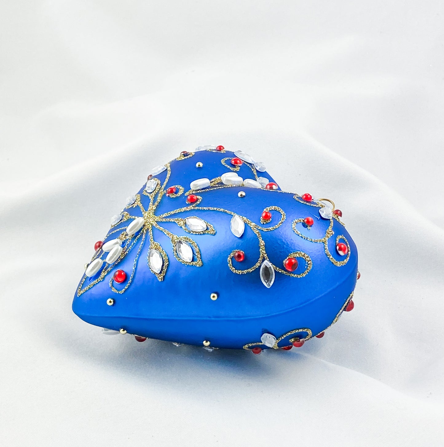 Blue heart with pearls and red gemstones