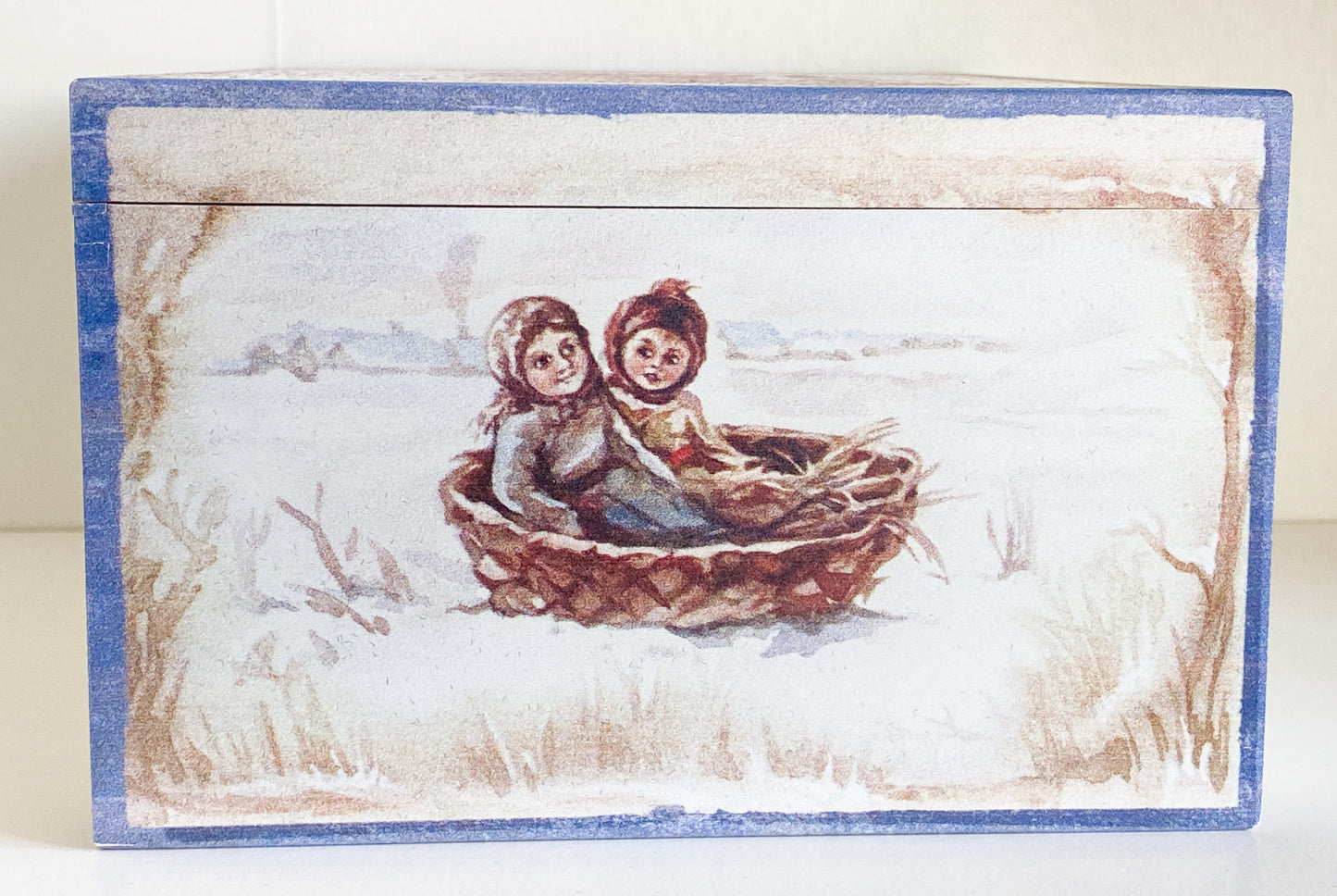 Two children in a hedgehog sleigh, set of 2, in a wooden box