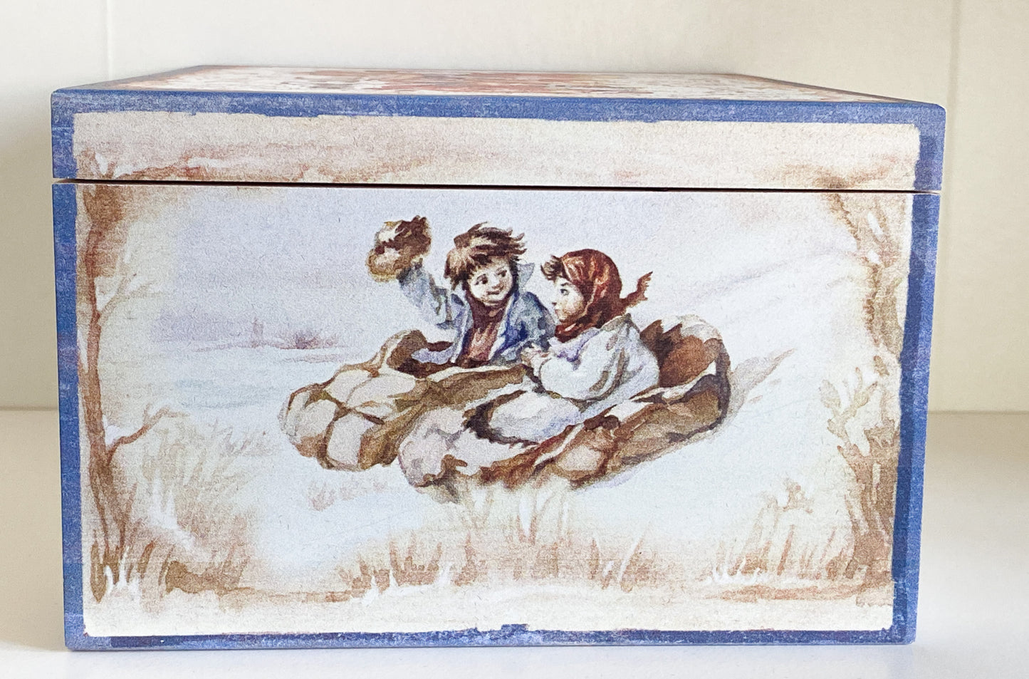Two children in a hedgehog sleigh, set of 2, in a wooden box